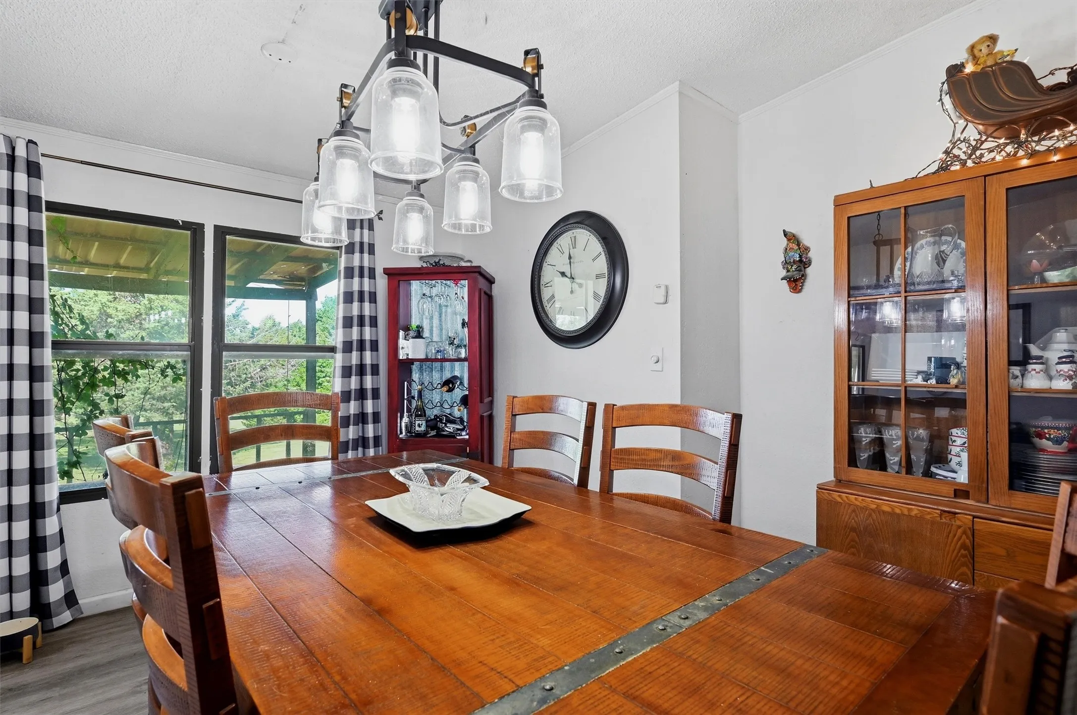 Dining area featuring a multi-light chandelier, and large windows