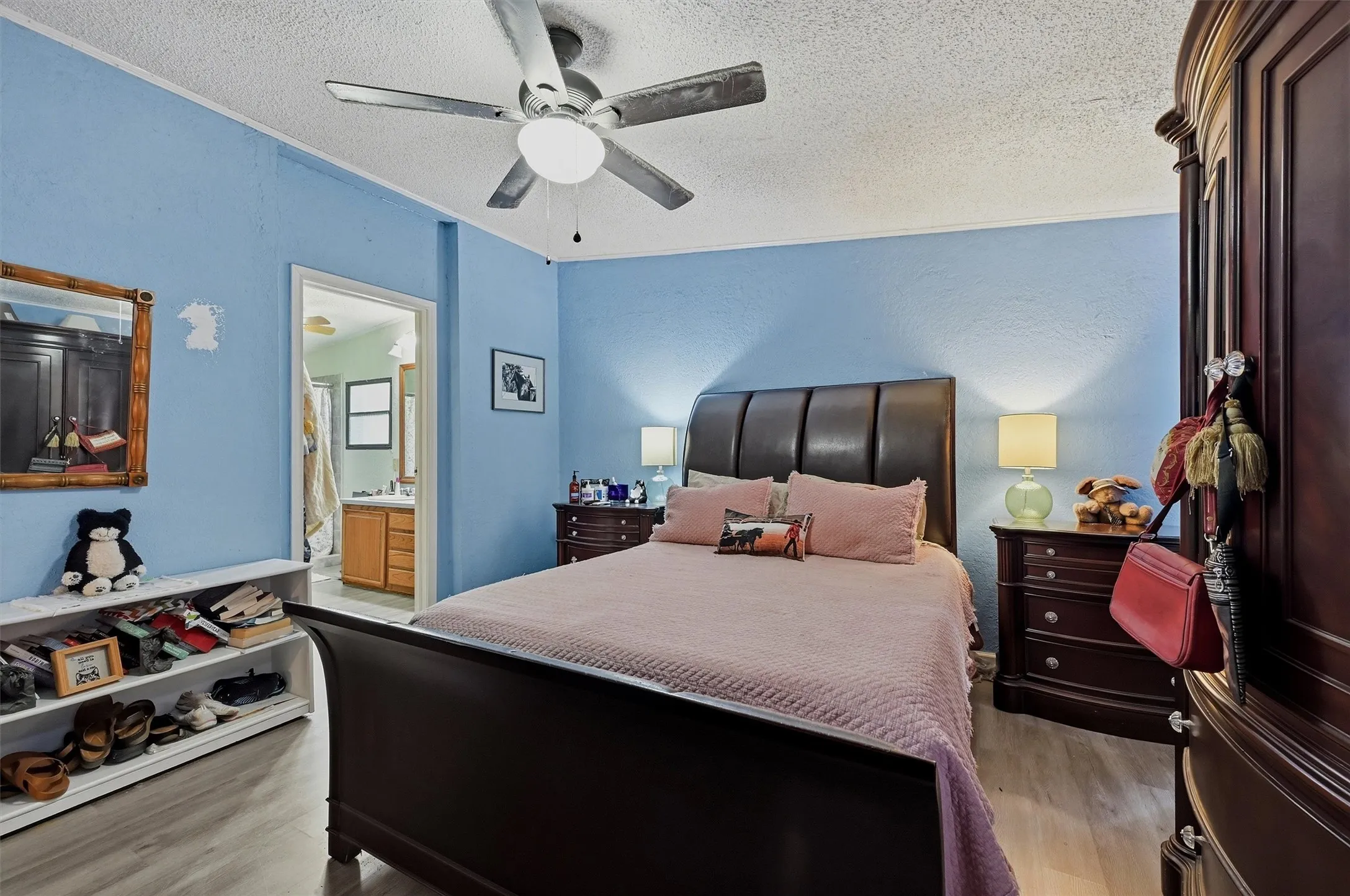 Bedroom featuring wood-finish flooring and a ceiling fan with integrated lighting