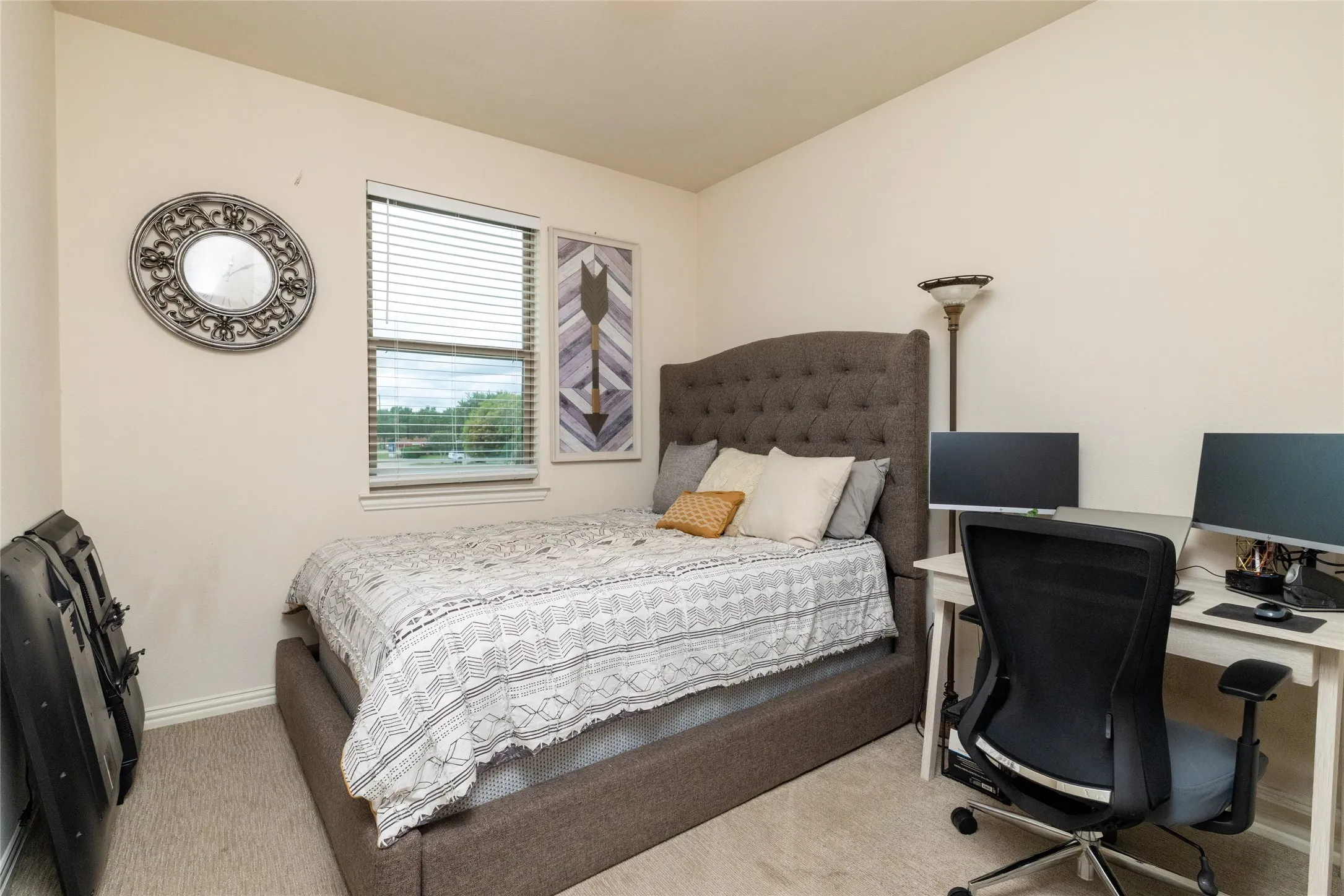 Carpeted room with a single window, white baseboards, and neutral wall paint