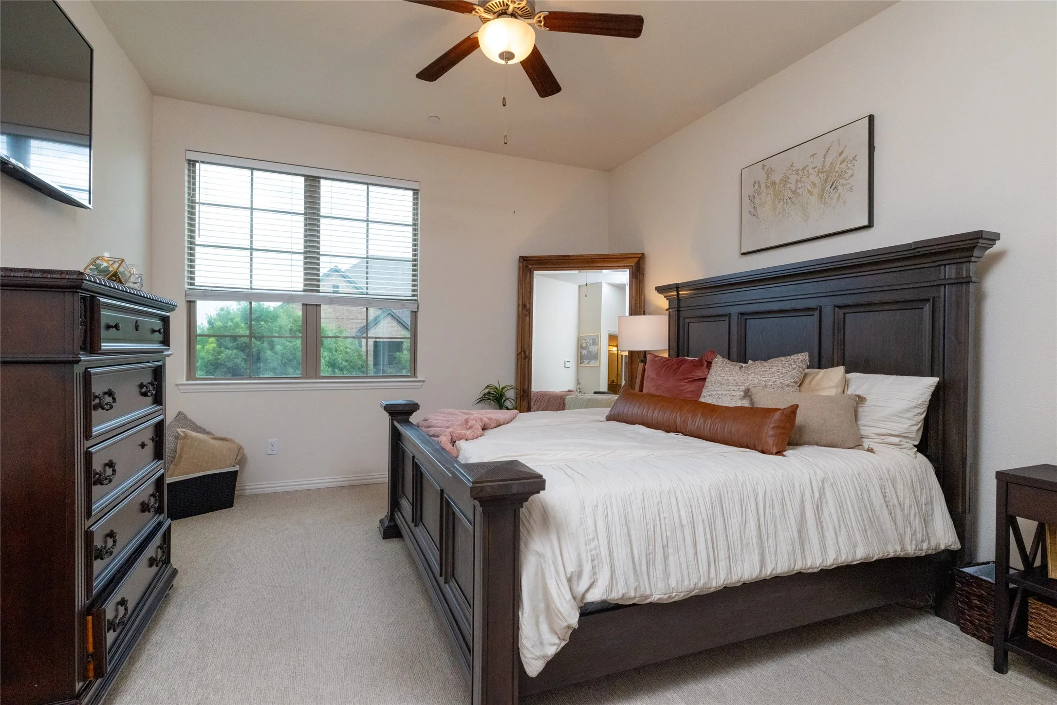 Carpeted room featuring a large window with blinds, ceiling fan, and recessed lighting