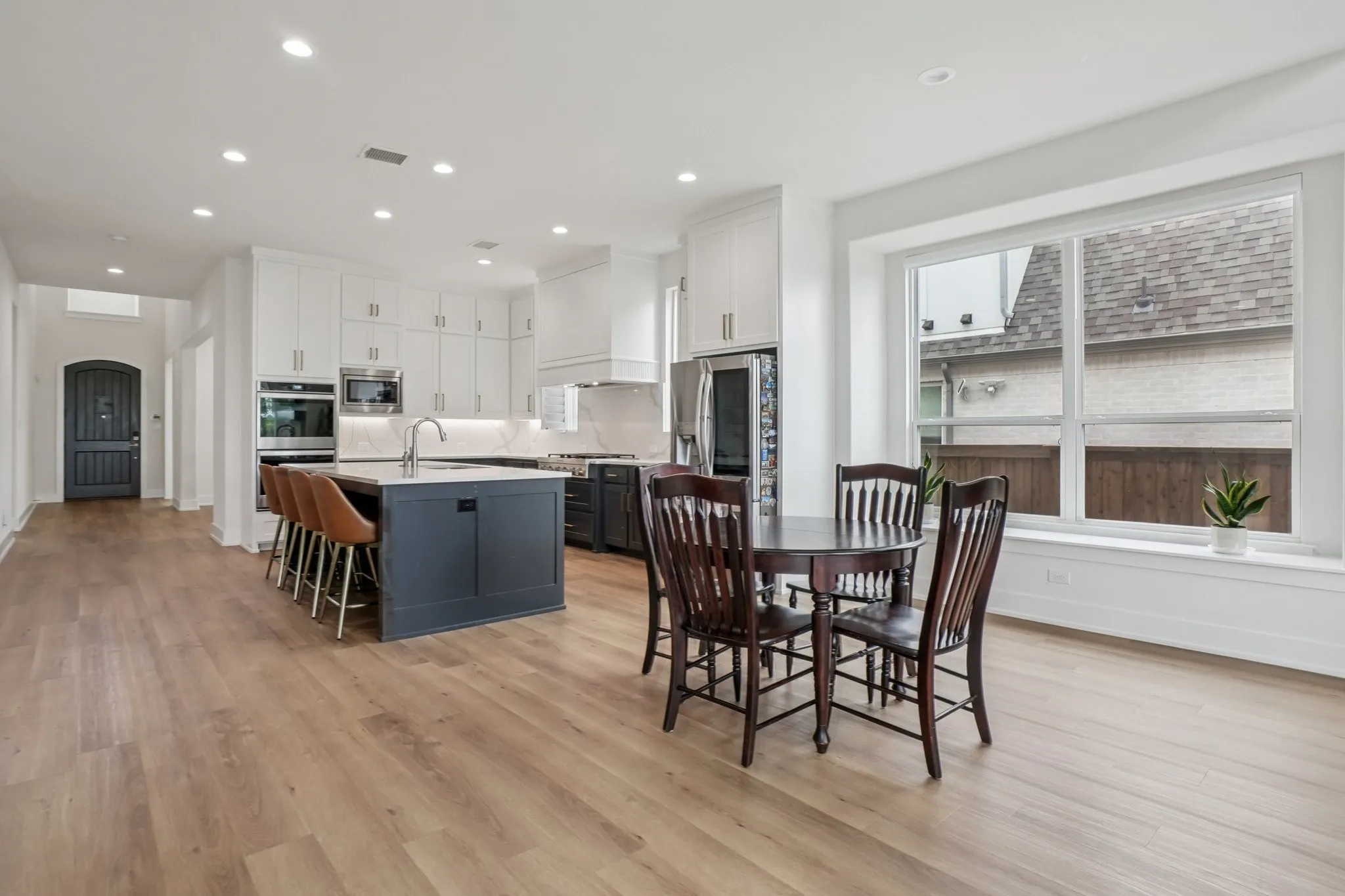 Open-concept kitchen and dining area featuring light wood-finish flooring