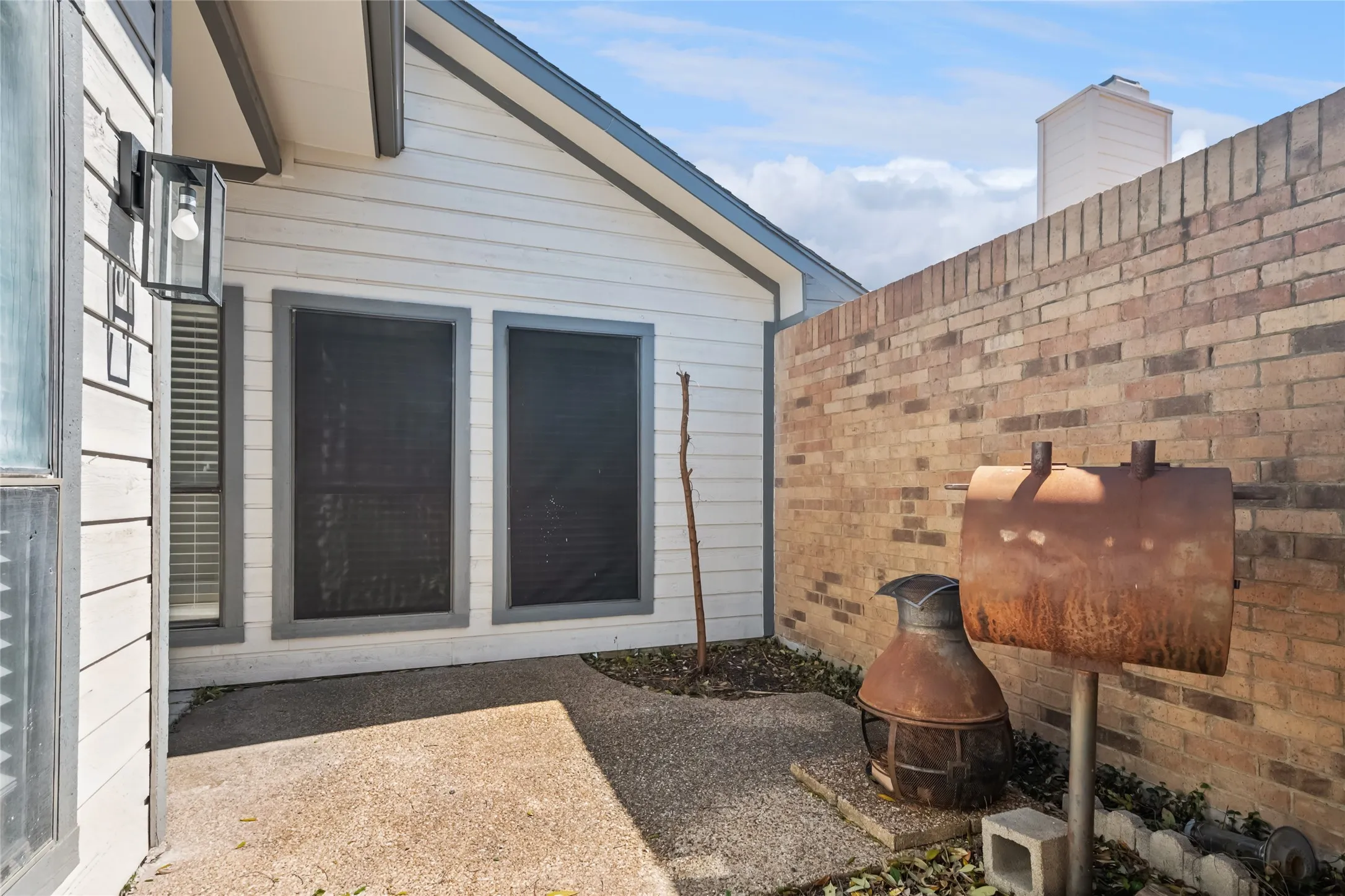 Entrance to property featuring a patio area, brick siding, and heating fuel