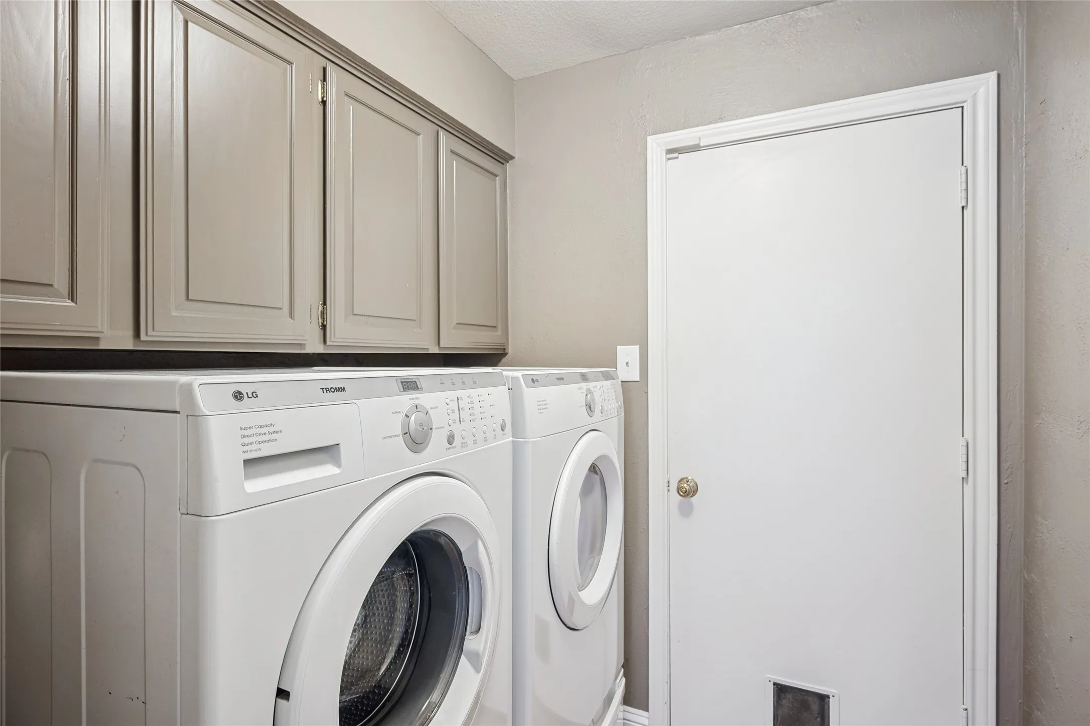 Laundry area featuring cabinet space and separate washer and dryer