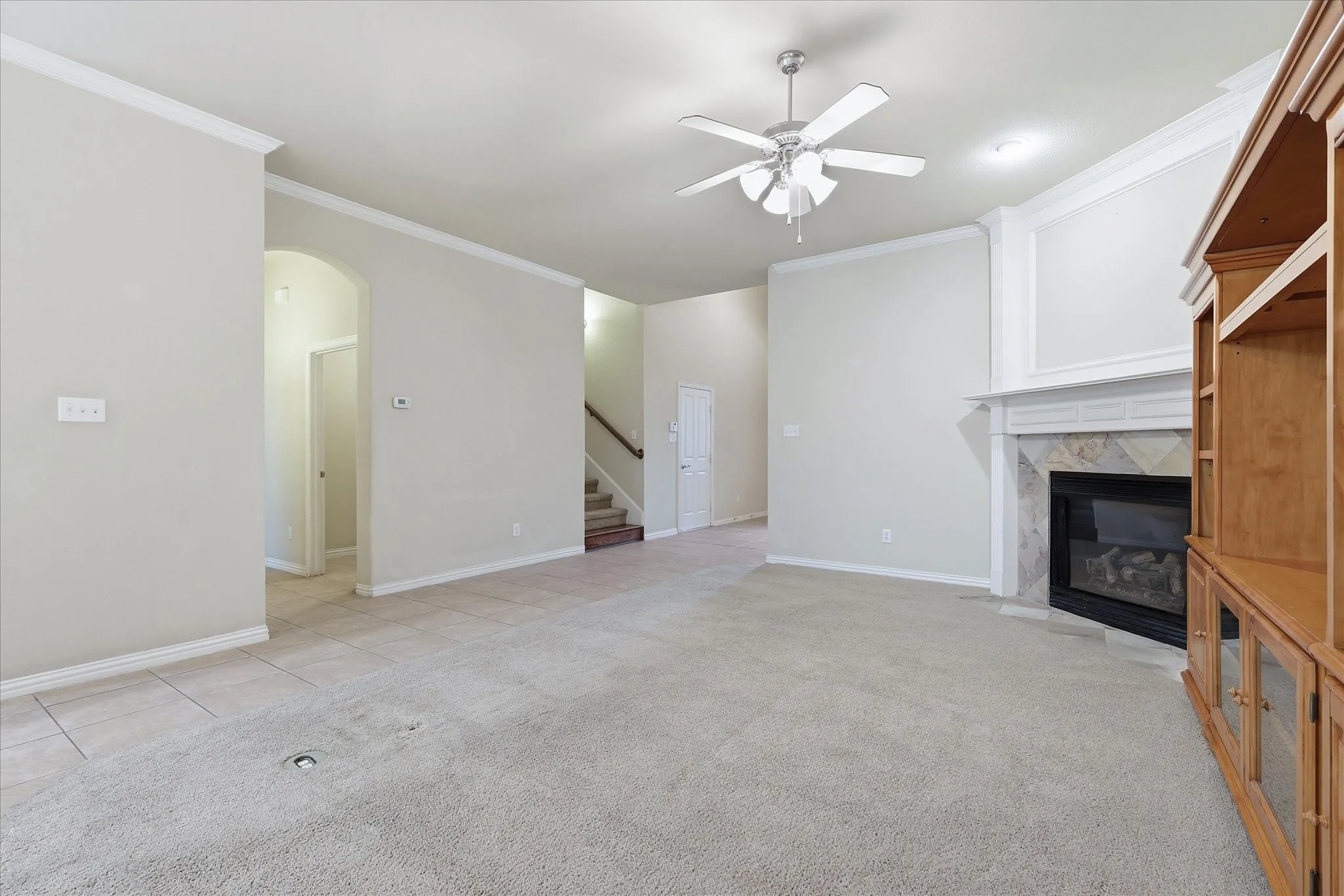 Large living features a secluded hallway that leads to the laundry room, half bath, and primary suite.