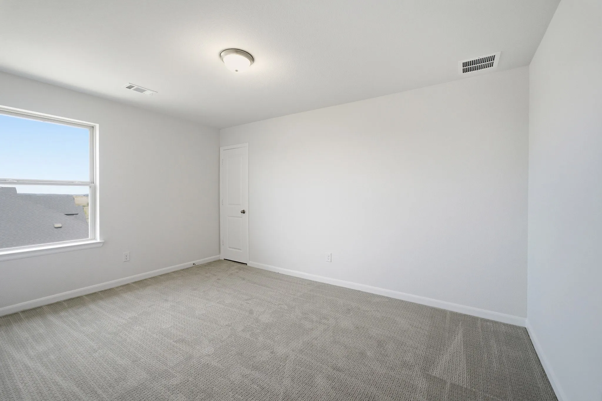 Carpeted room with a white door, single window, and ceiling light fixture