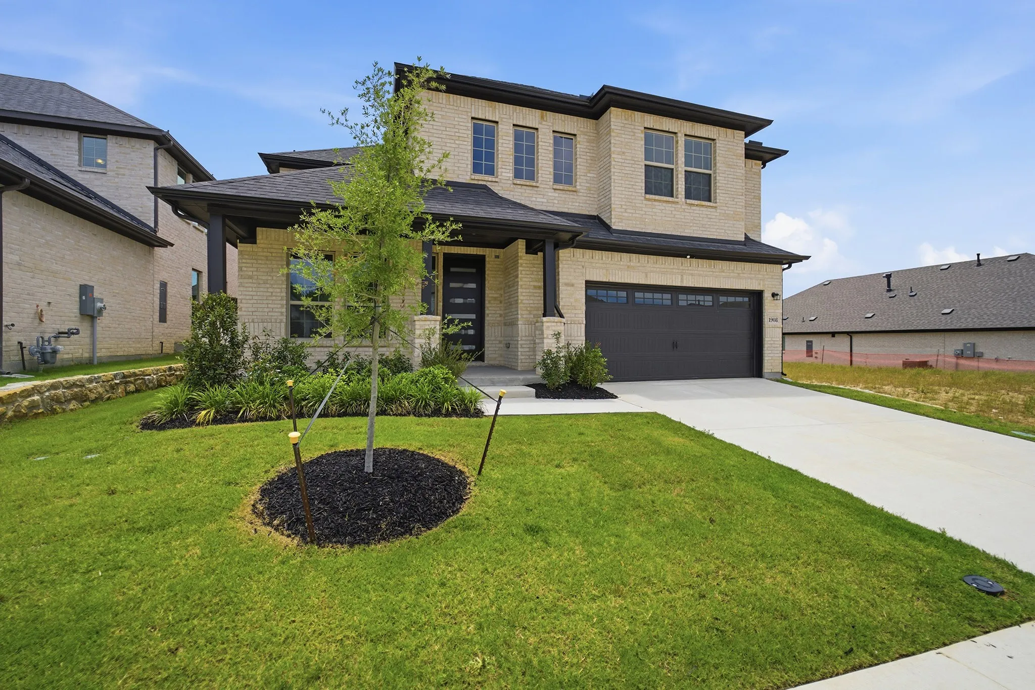 Contemporary two-story residence with light-colored brick facade