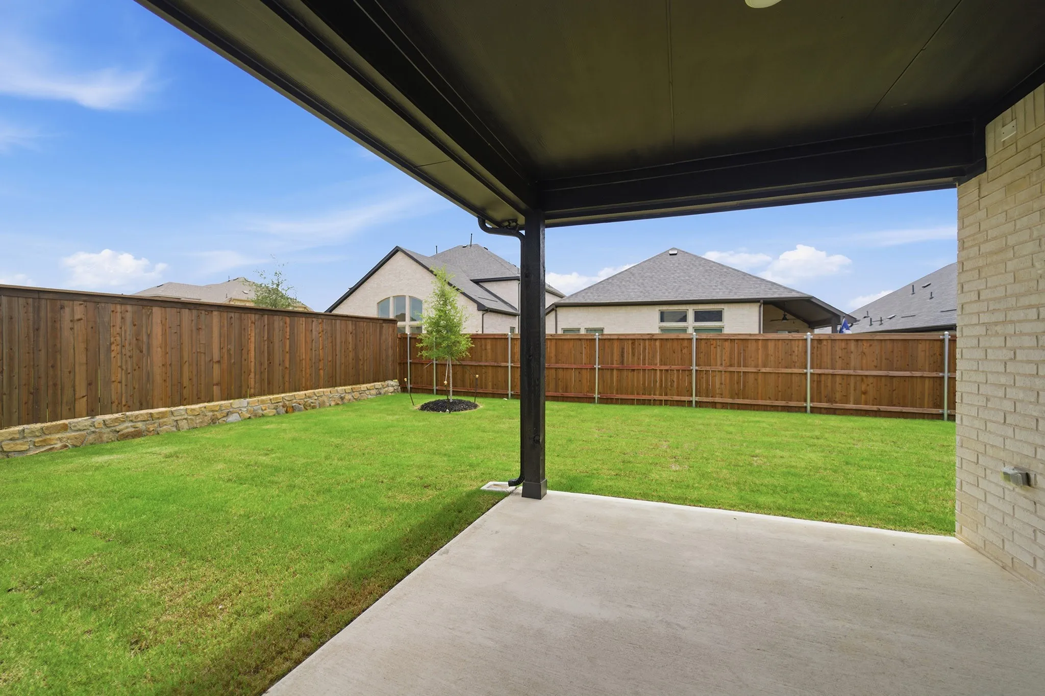 Covered outdoor patio with a concrete surface