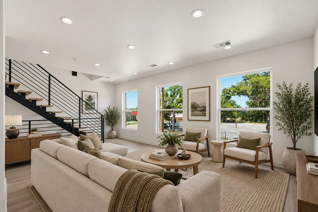 Open-concept living space with recessed lighting, large windows, and light wood-finish flooring