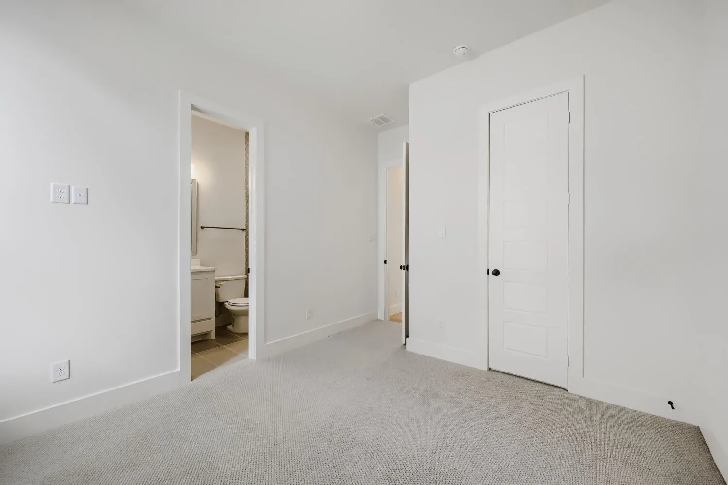 Light gray carpeting, white walls, and white trim throughout