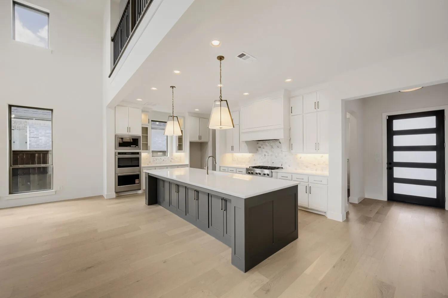 Two-story living area with wood-finish flooring