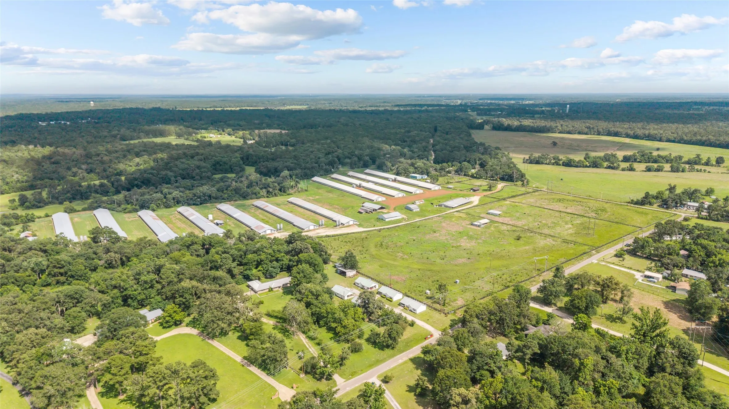 Expansive agricultural property featuring multiple pou, extensive open land, and perimeter fencing