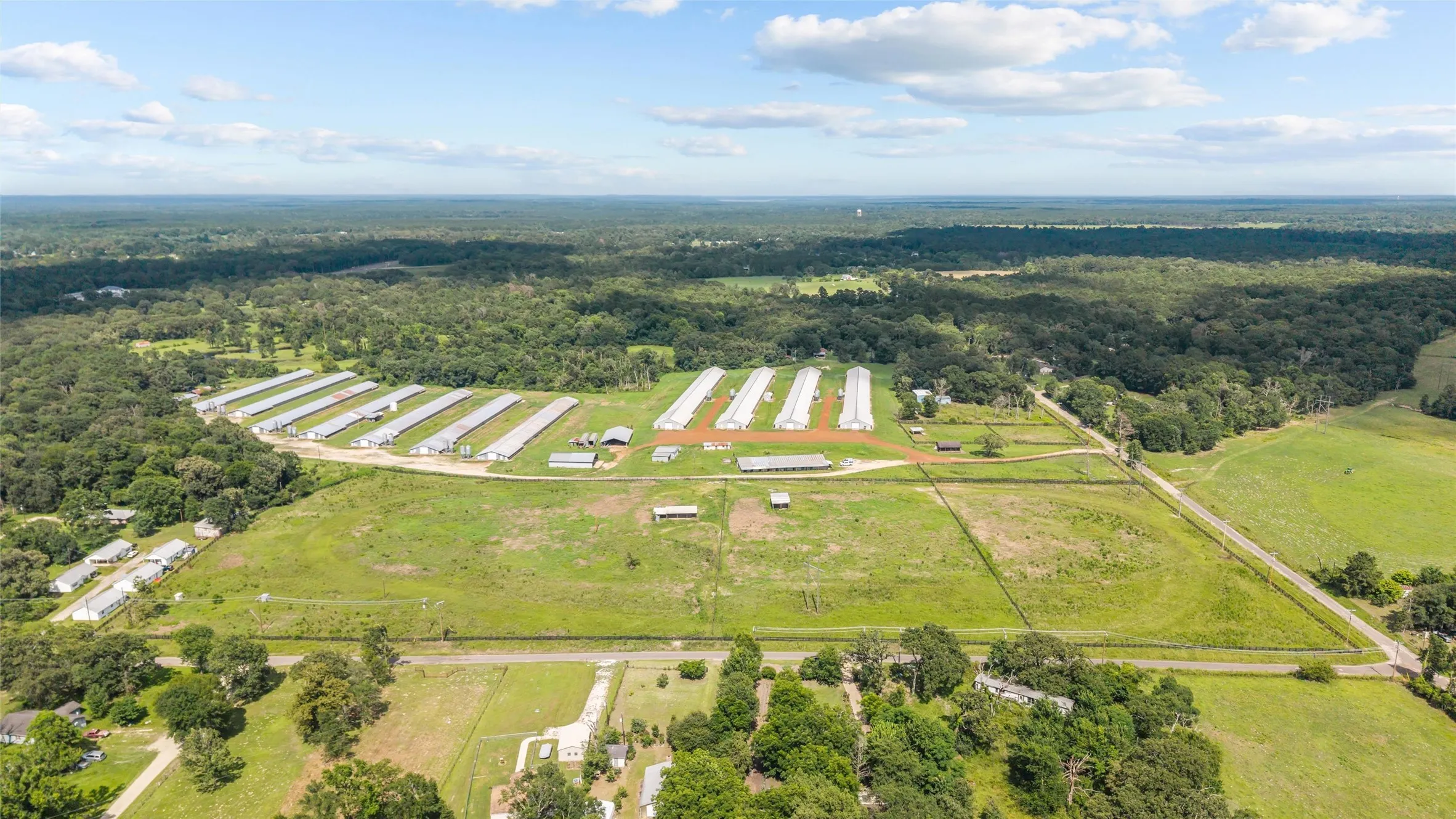 Expansive agricultural property featuring multiple pou, extensive open land, and perimeter fencing