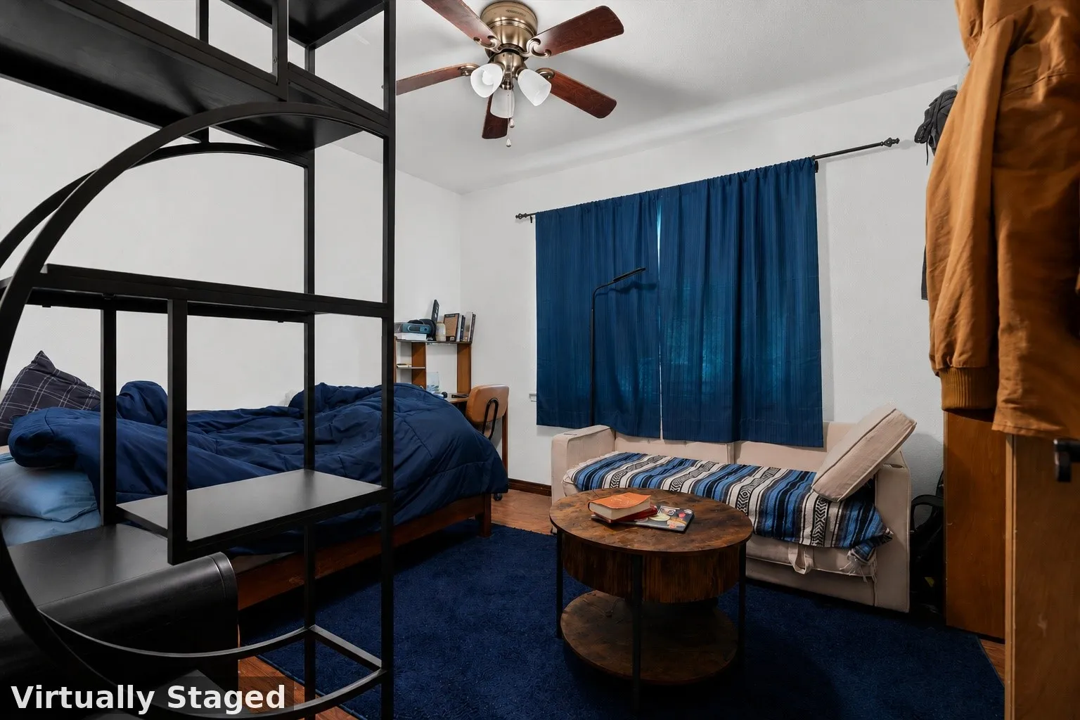 Bedroom featuring wood-finish flooring, a ceiling fan with integrated lighting, and a white baseboard trim