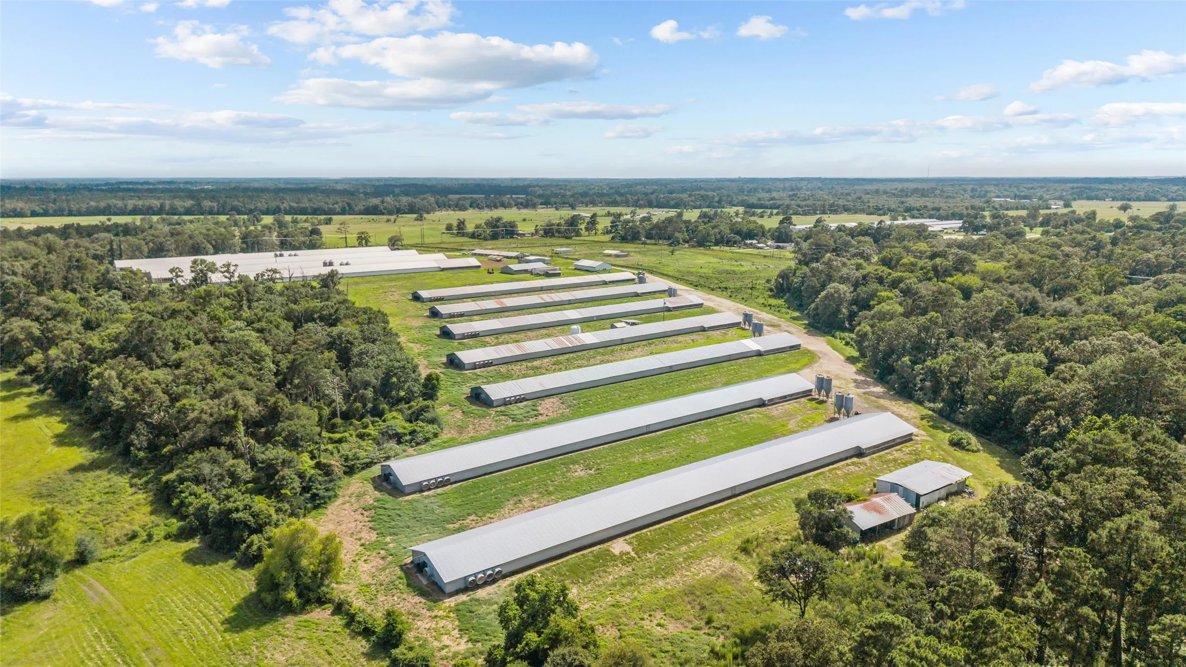 Expansive agricultural property featuring multiple pou, extensive open land, and perimeter fencing