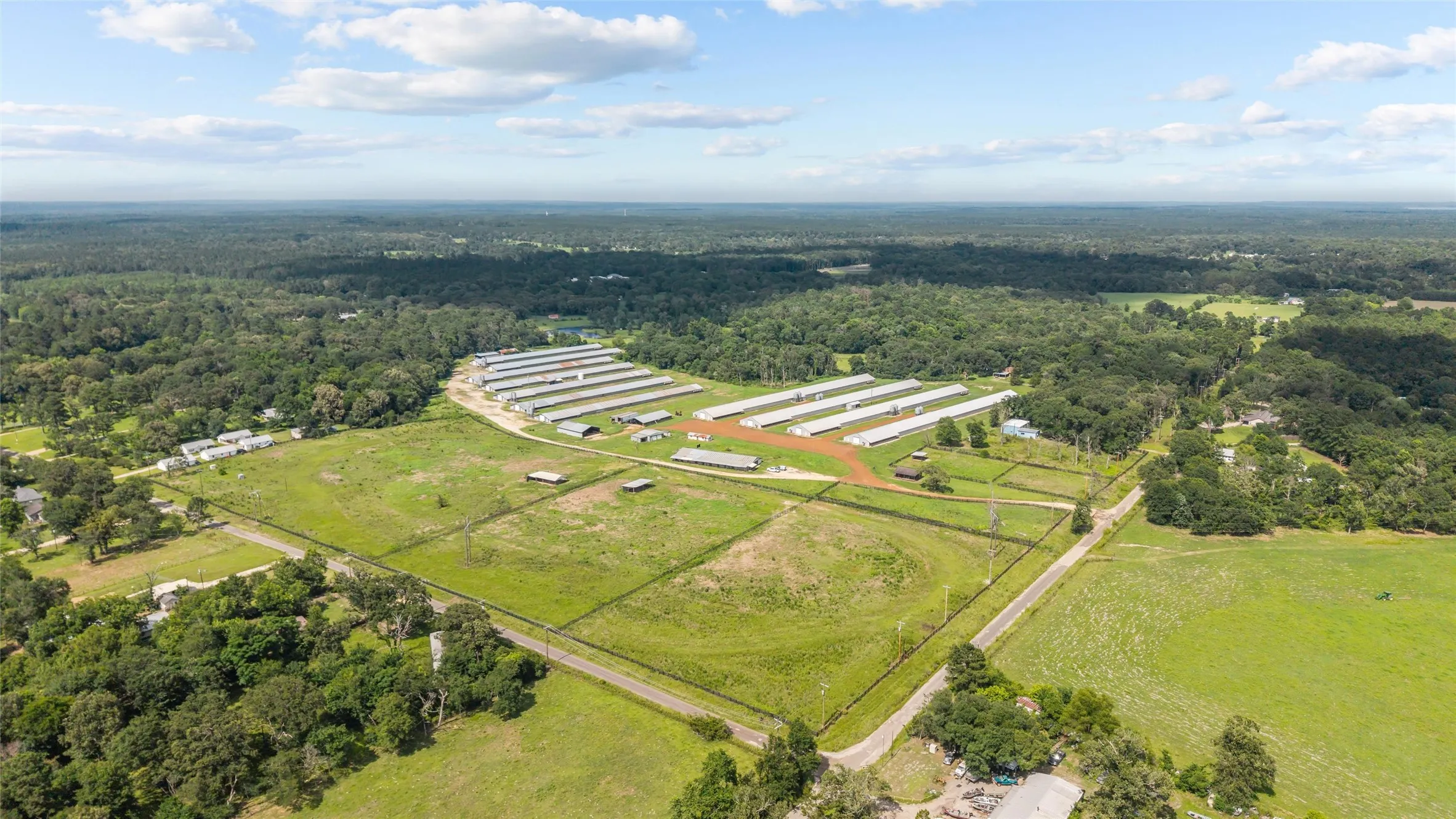 Expansive agricultural property featuring multiple pou, extensive open land, and perimeter fencing