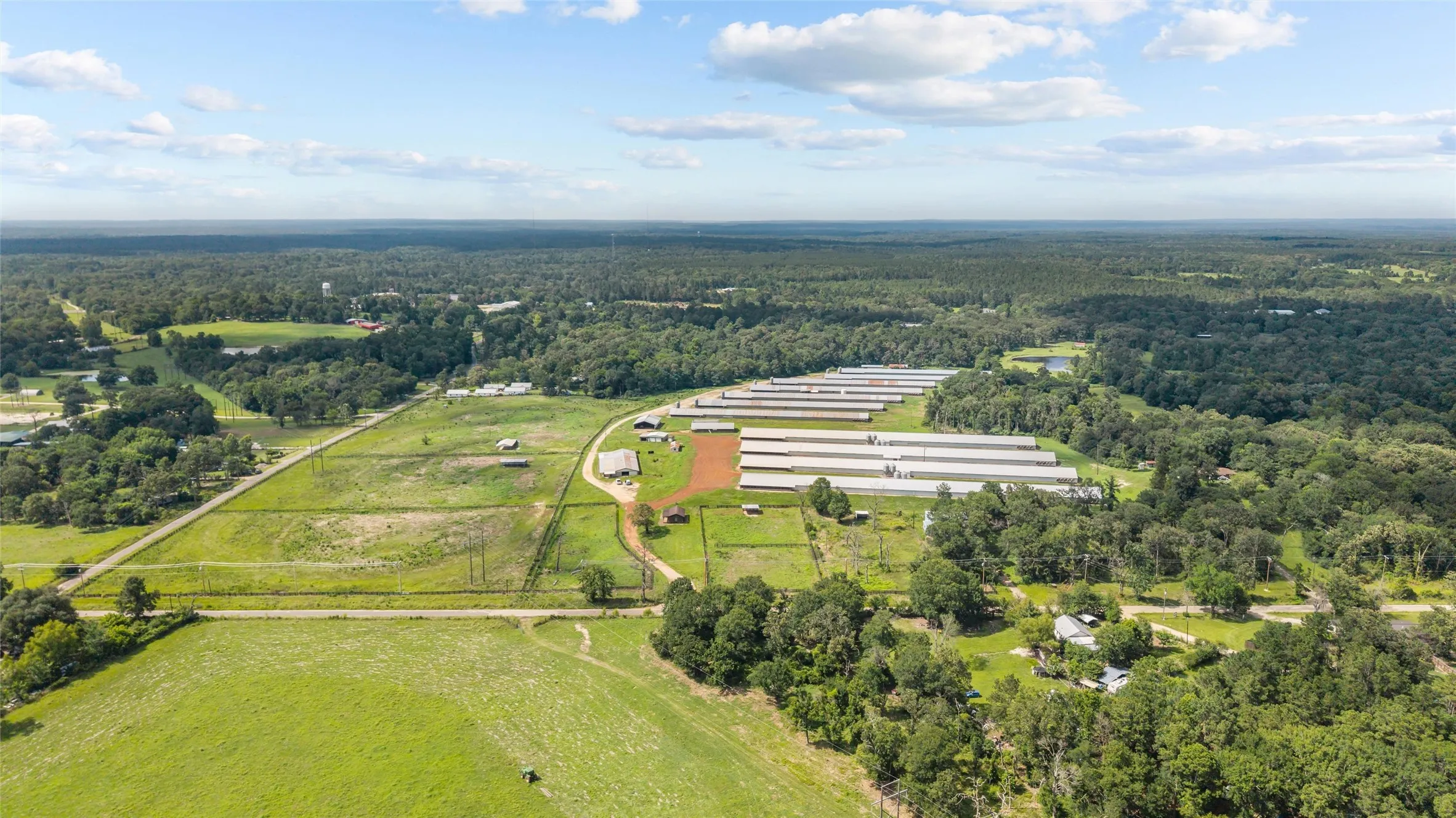Expansive agricultural property featuring multiple pou, extensive open land, and perimeter fencing