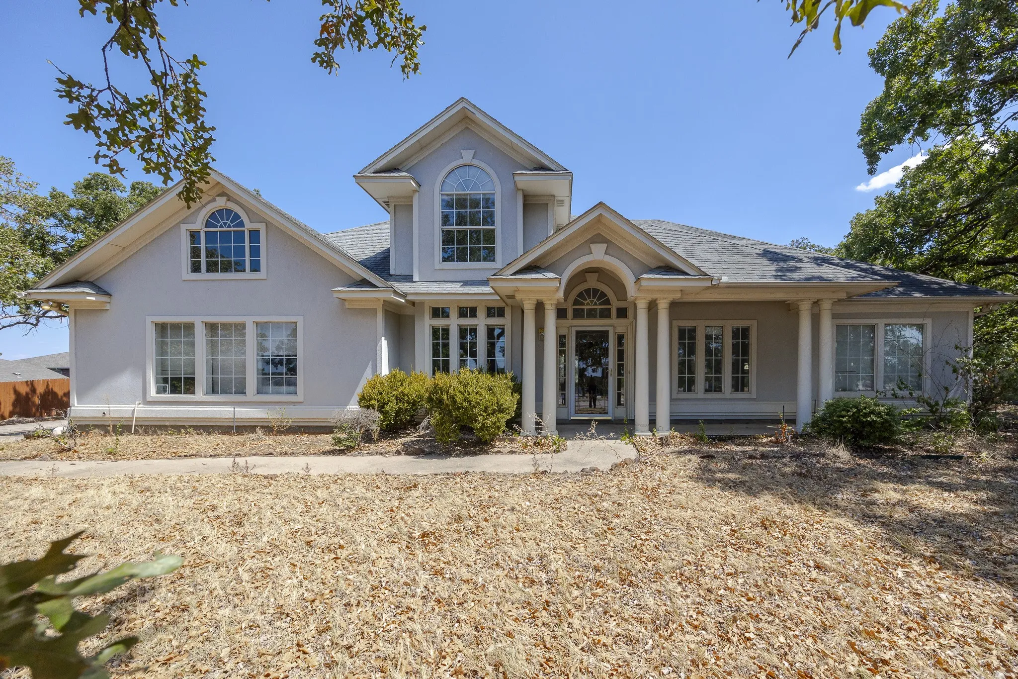 Stucco exterior with multiple gables and a covered entry