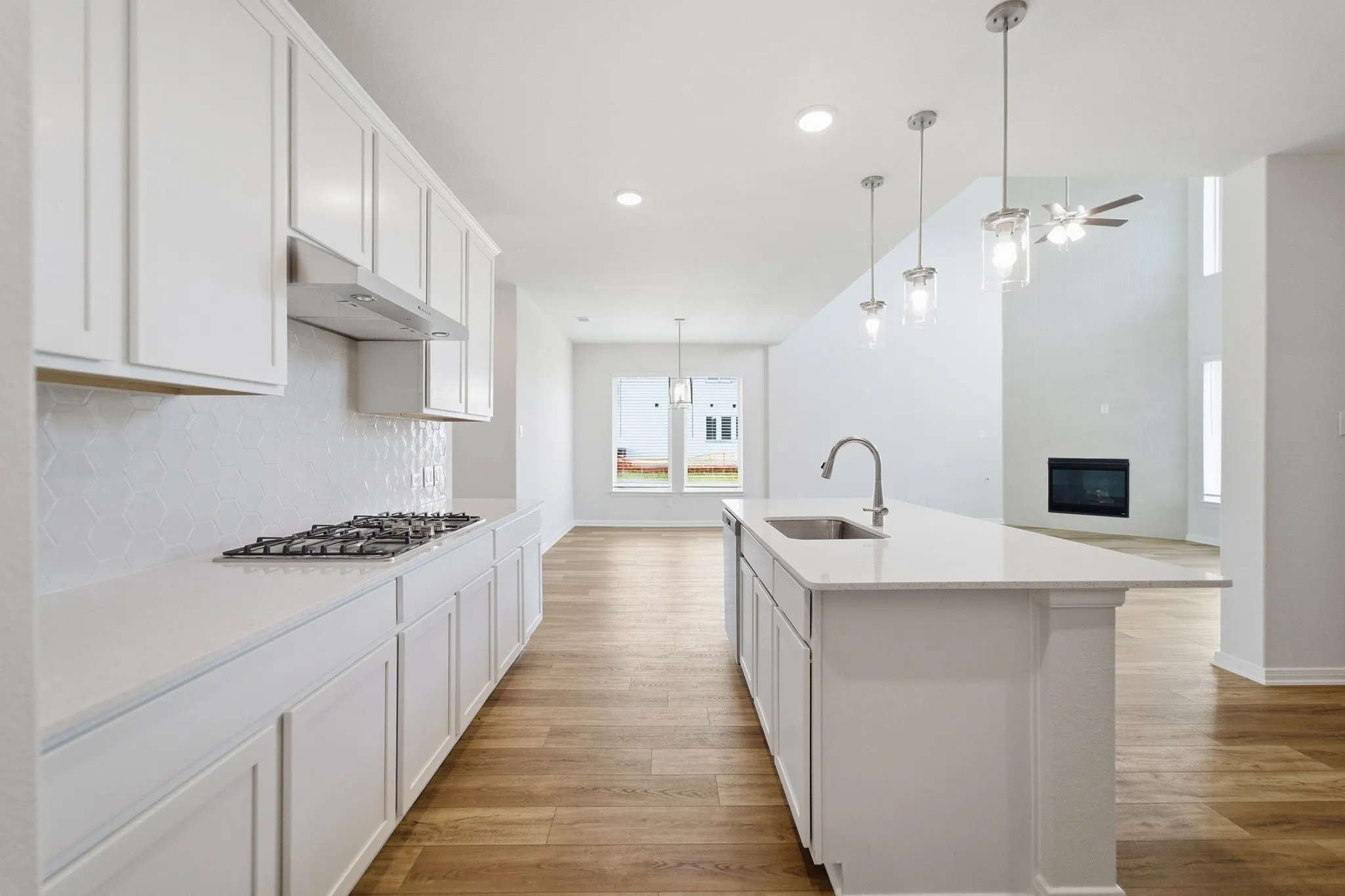 Kitchen with white cabinetry, a gas cooktop, and a matching tile backsplash