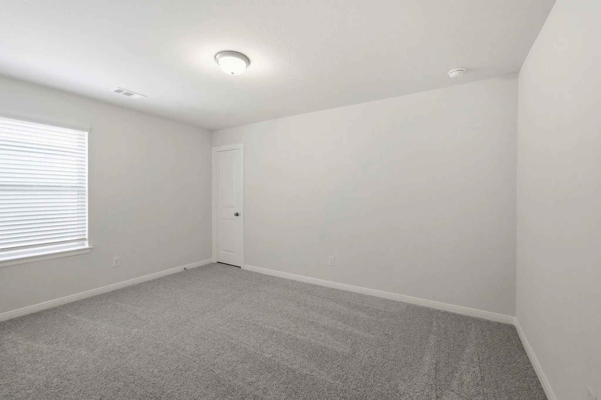 Light gray carpeting complements neutral wall tones