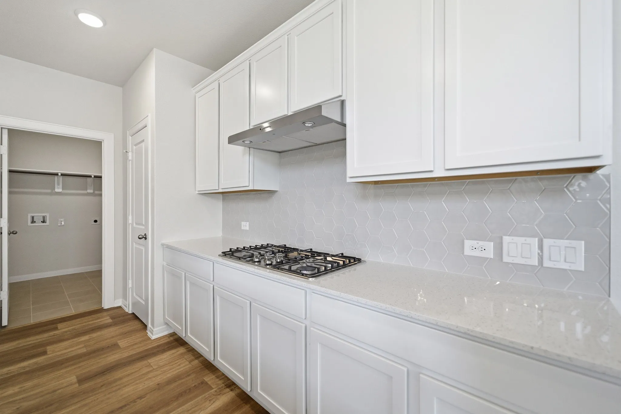 White shaker-style cabinetry with a built-in range hood