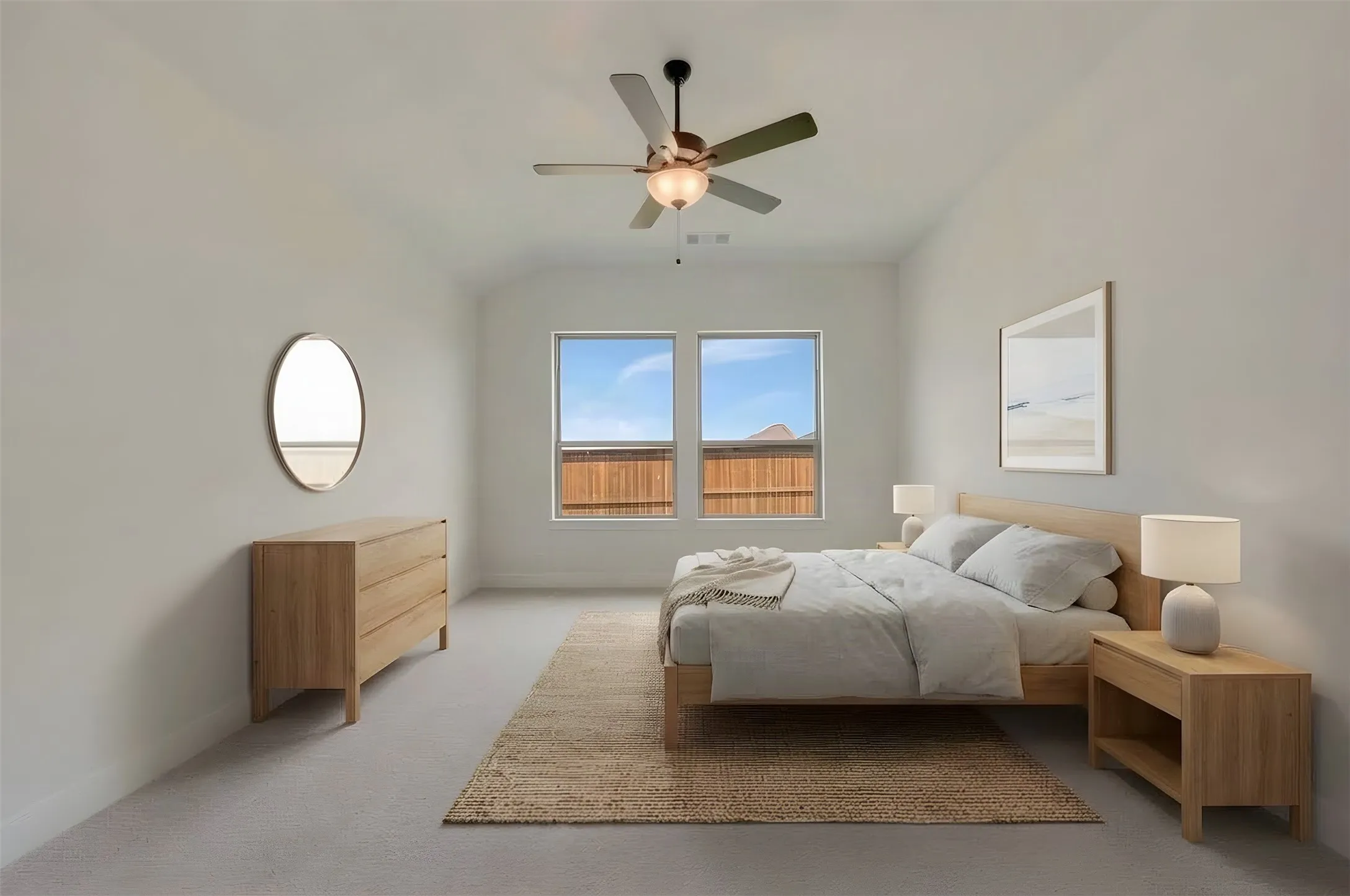 Spacious room with vaulted ceilings, neutral-toned walls, two large windows, and a ceiling fan with integrated lighting