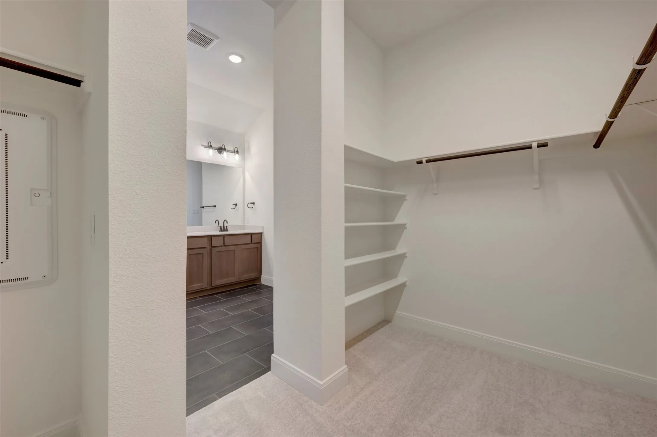 Walk-in closet with built-in shelving and hanging rods