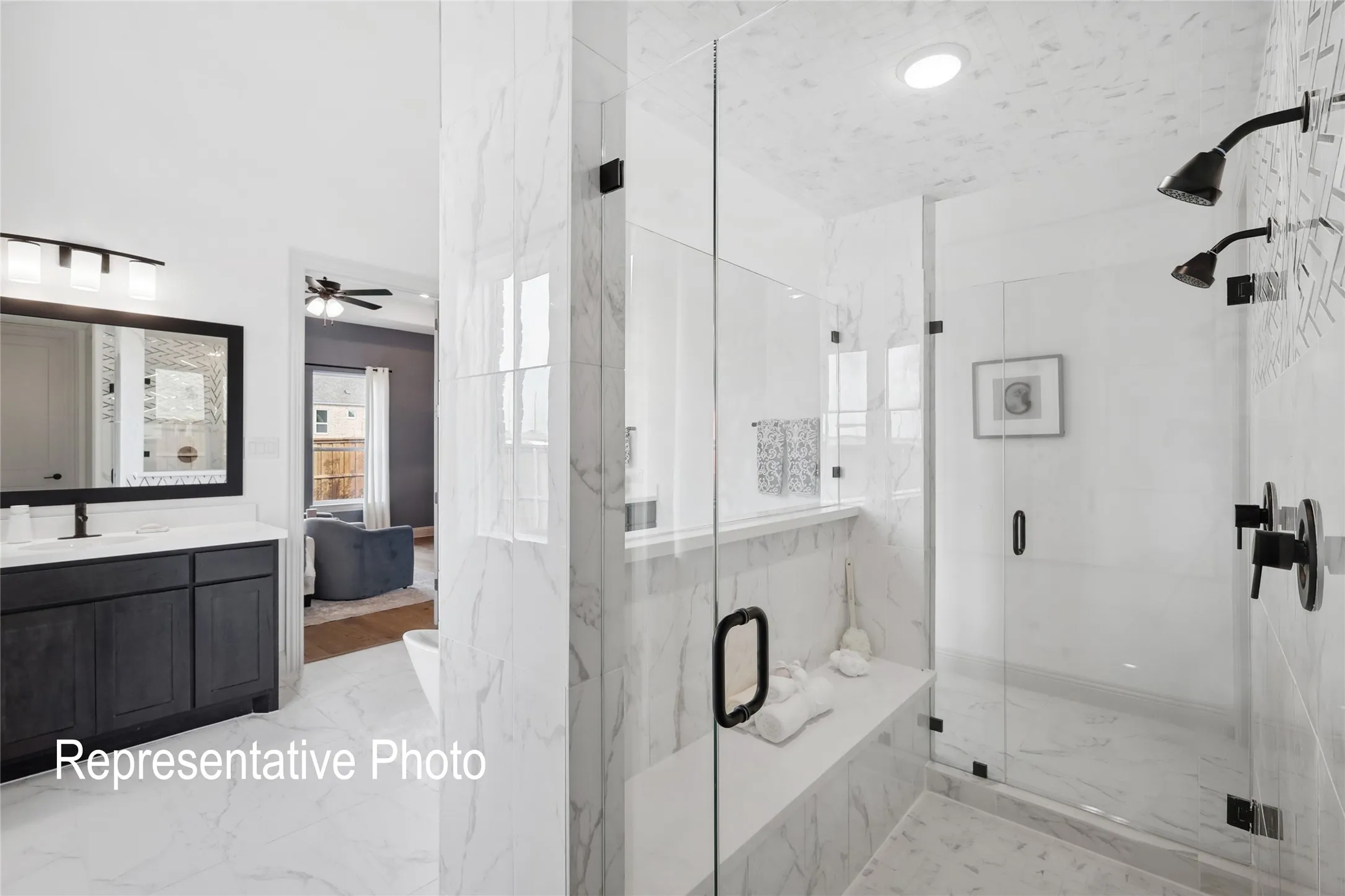 Spacious bathroom featuring a frameless glass shower enclosure with dual showerheads, a built-in shower bench, and tile flooring