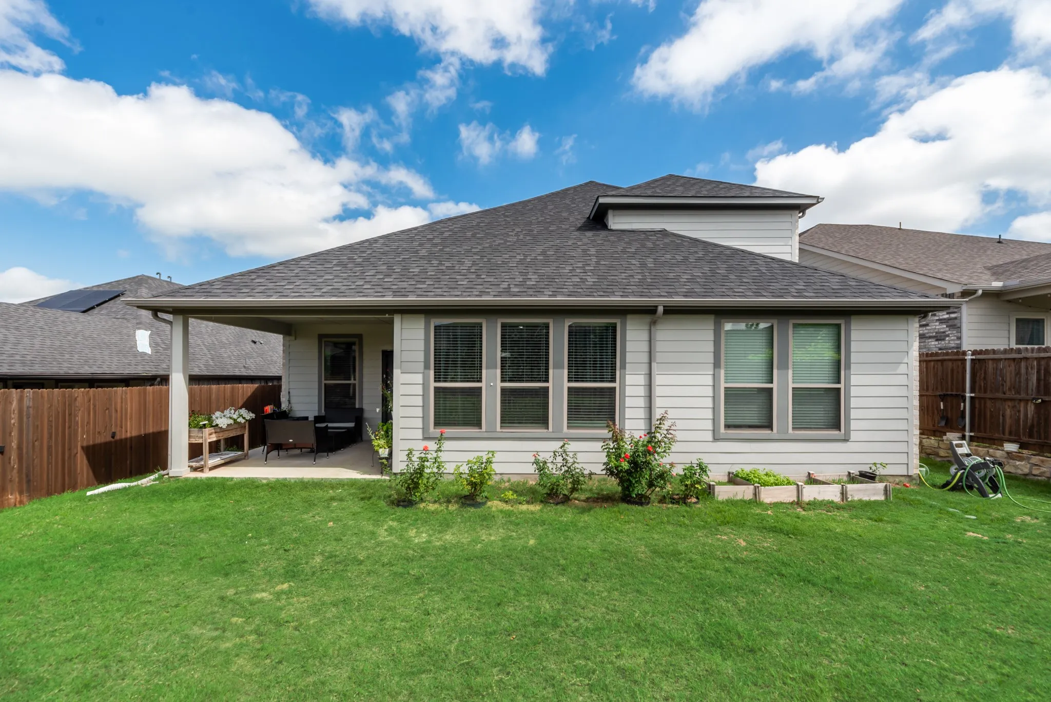 Expansive green lawn with a covered patio