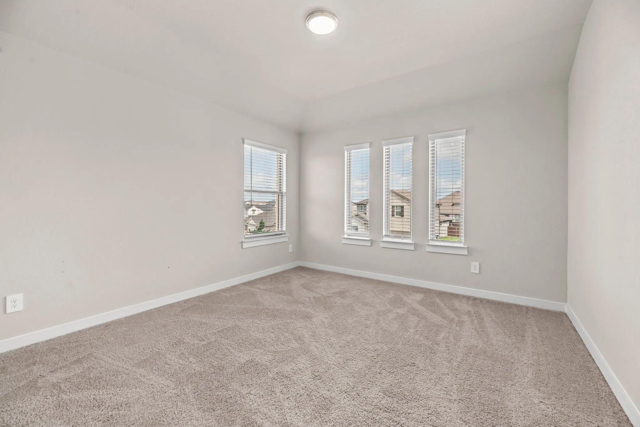 Neutral-toned walls complement the textured carpeting