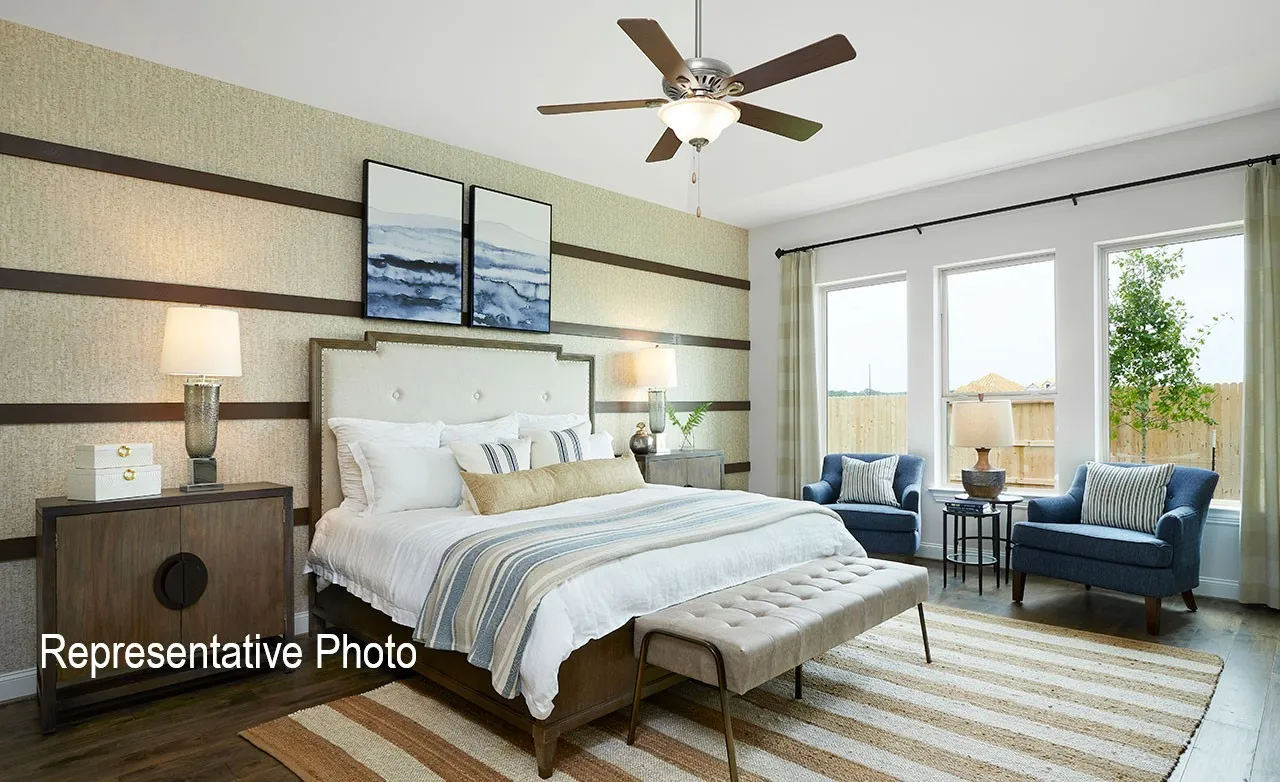 Spacious room featuring wood-finish flooring and a ceiling fan with integrated lighting