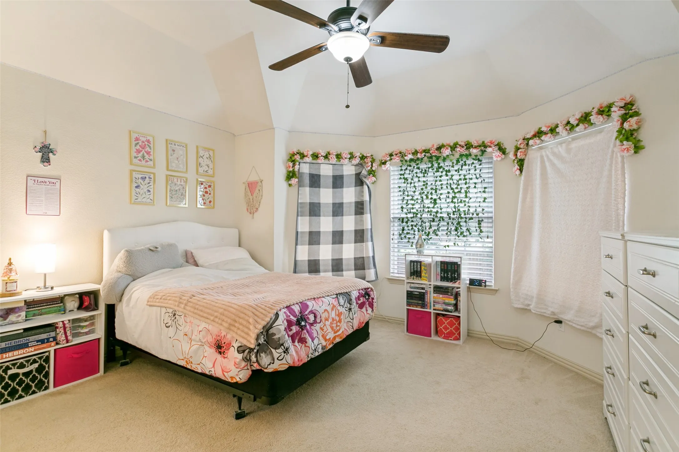 Bedroom featuring a tray ceiling, ceiling fan with integrated lighting, and carpet flooring