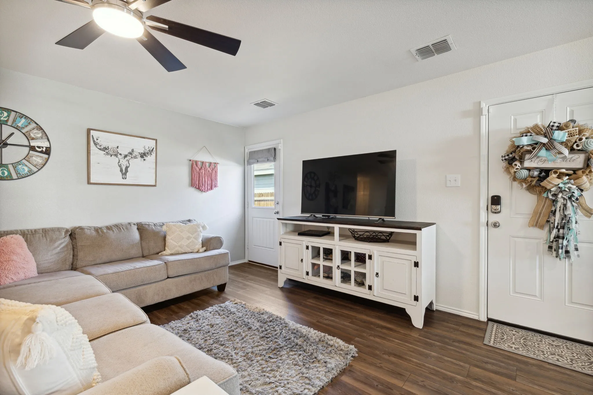 In the living room you access the main entry, on the right, and the door to the backyard on the left.