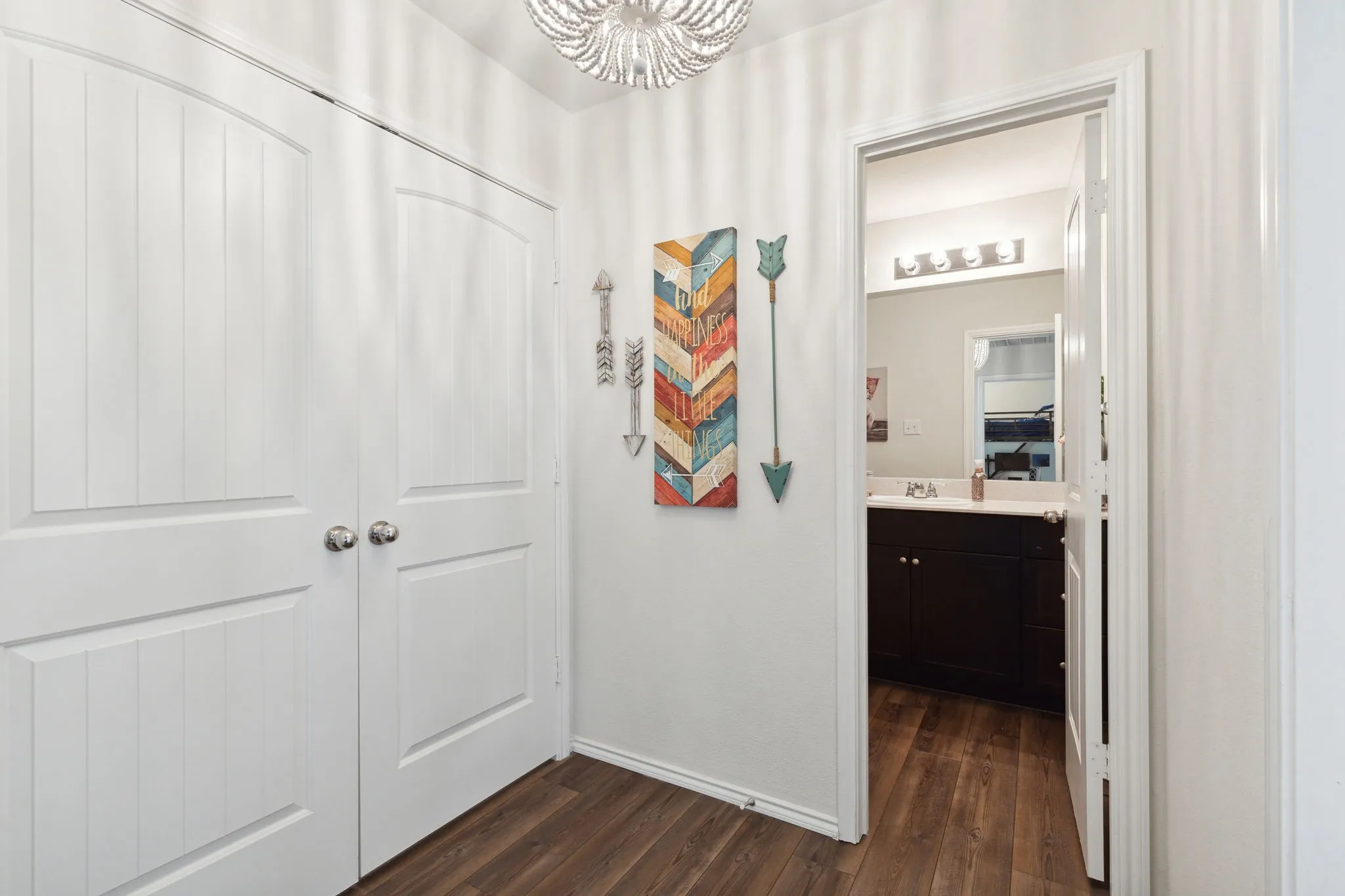 The hallway with access to the bathroom and the laundry closet.
