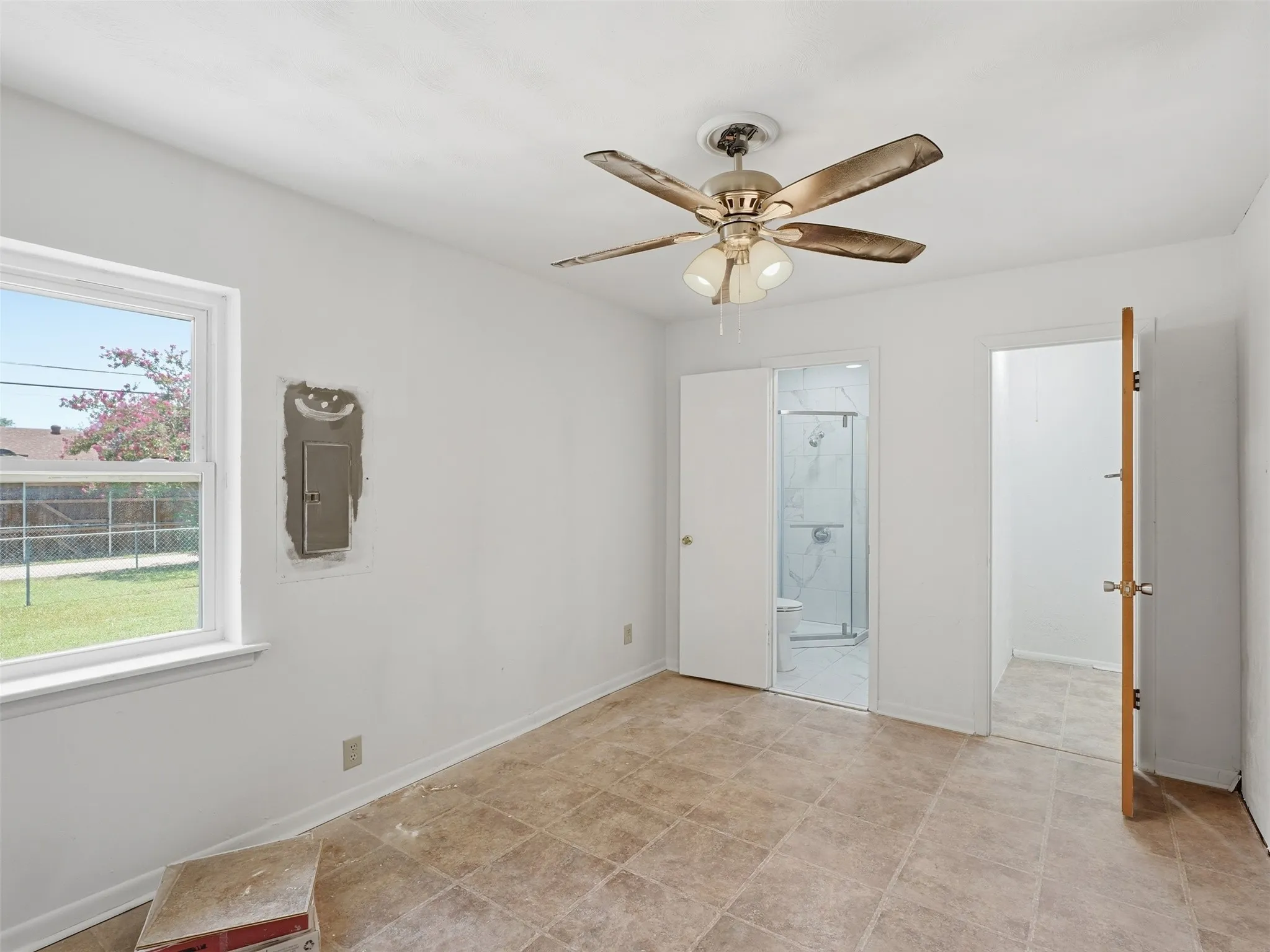 Interior room with ceramic tile flooring, a ceiling fan with integrated lighting, and a double-hung window