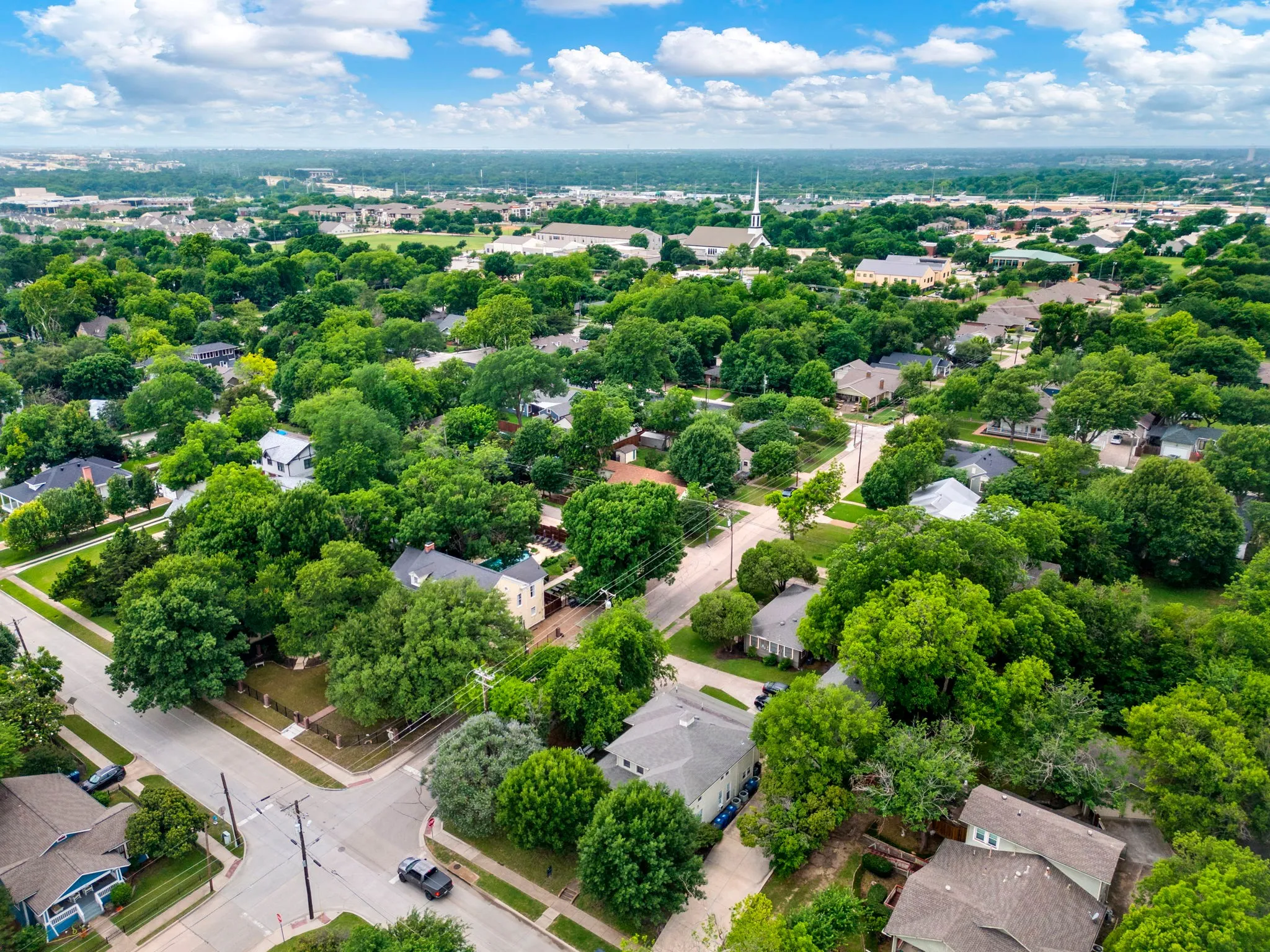 Aerial perspective showcasing a residential area with extensive tree canopy
