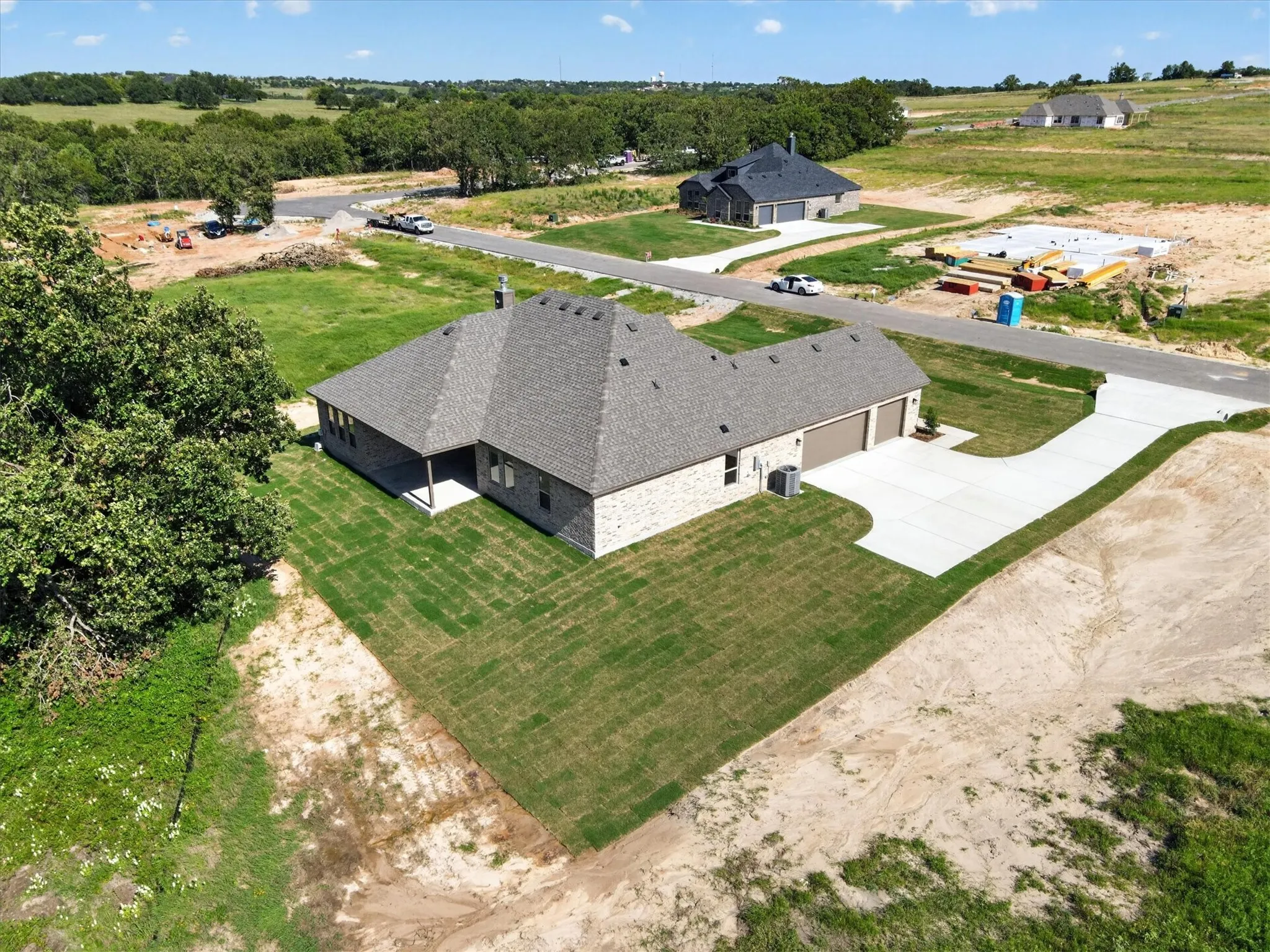 Single-story residence featuring a brick exterior and a dark shingle roof