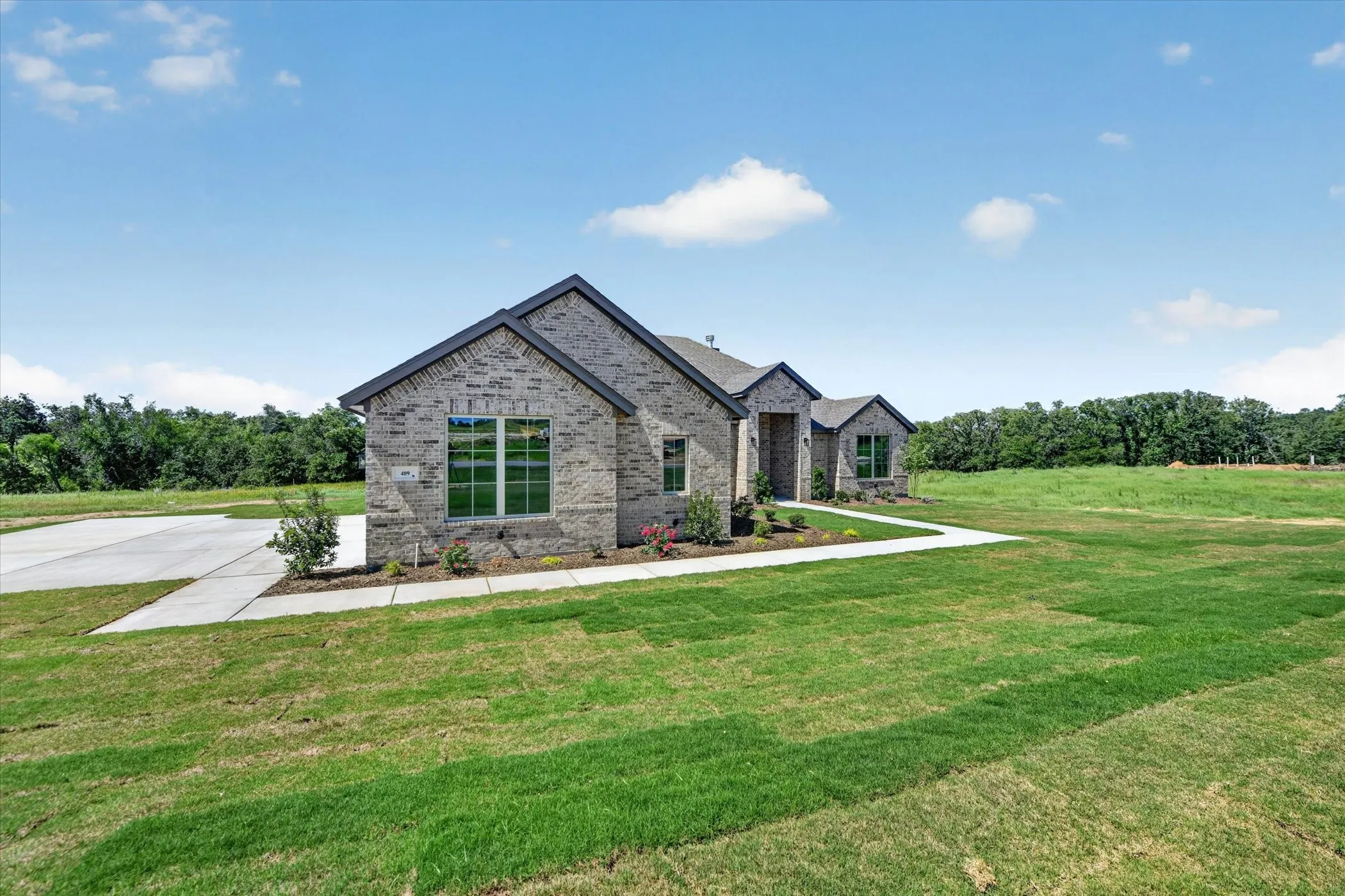 Brick exterior with dark gray roofing