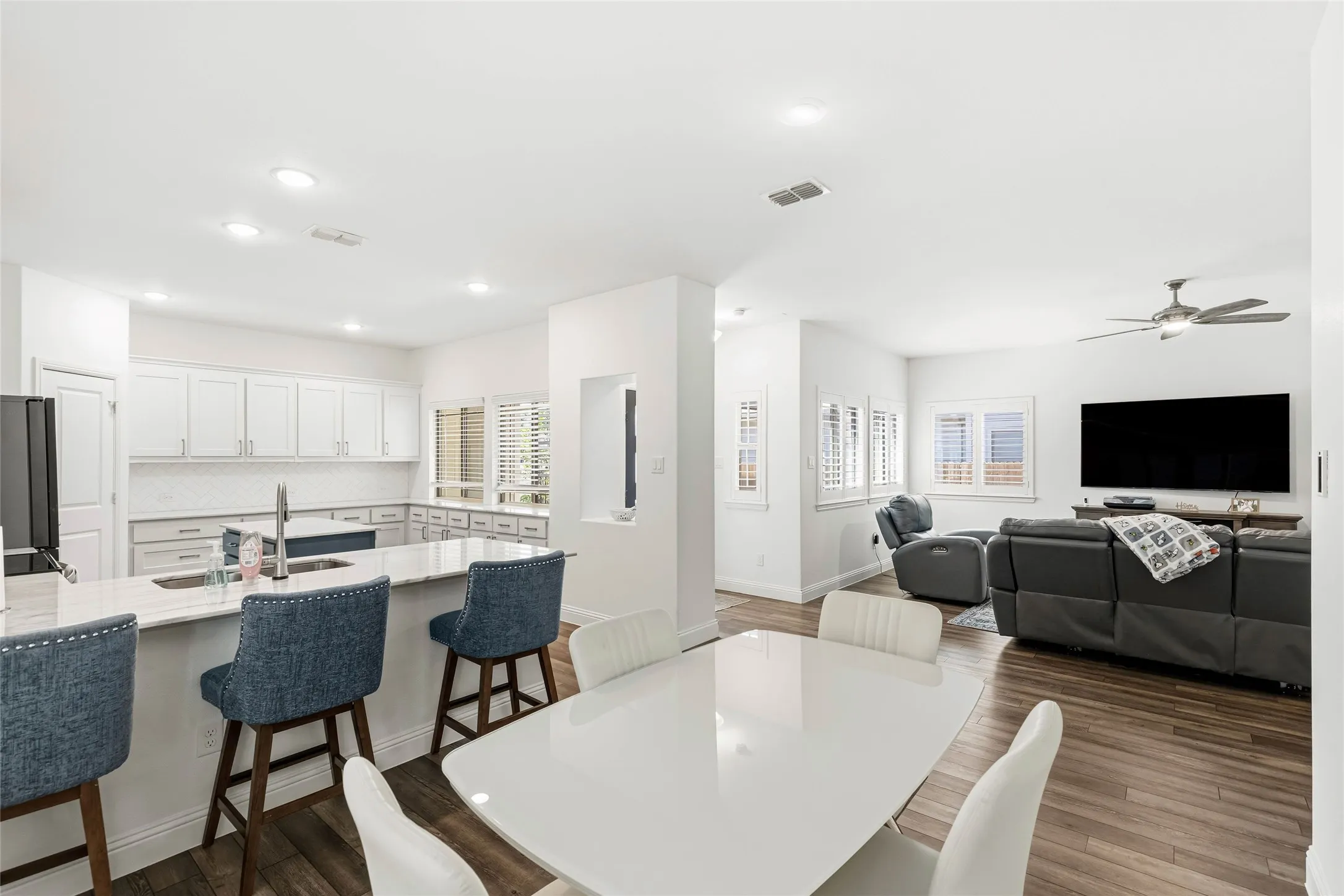Open-concept living space with wood-finish flooring throughout