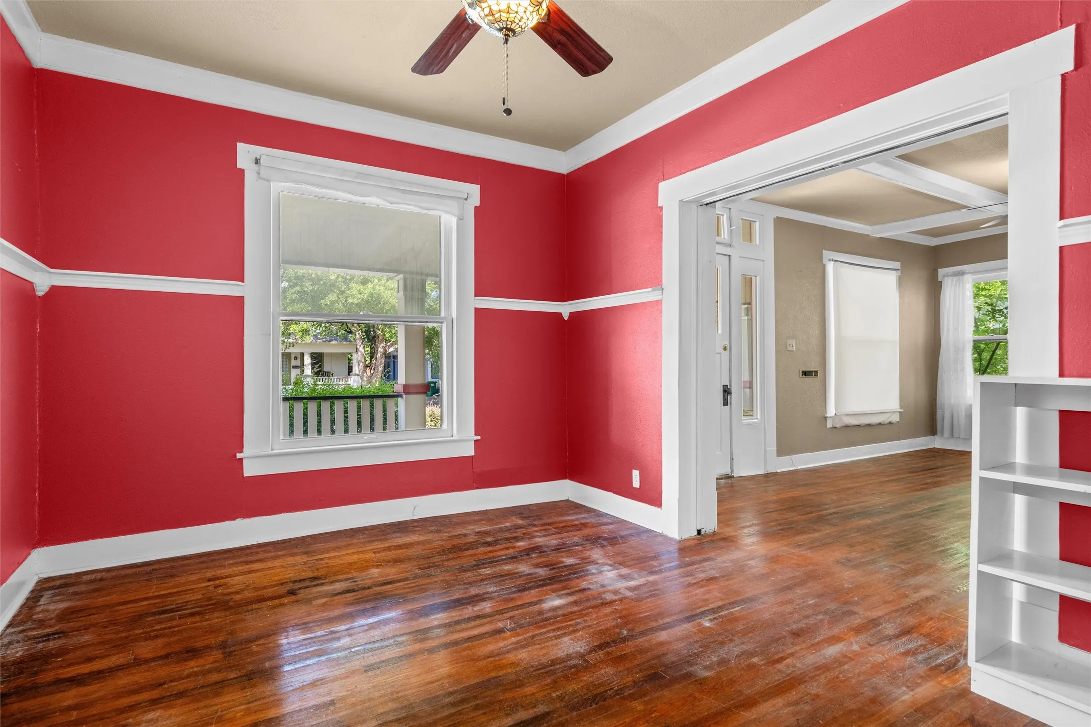 Interior room with wood-finish flooring and a decorative ceiling fan
