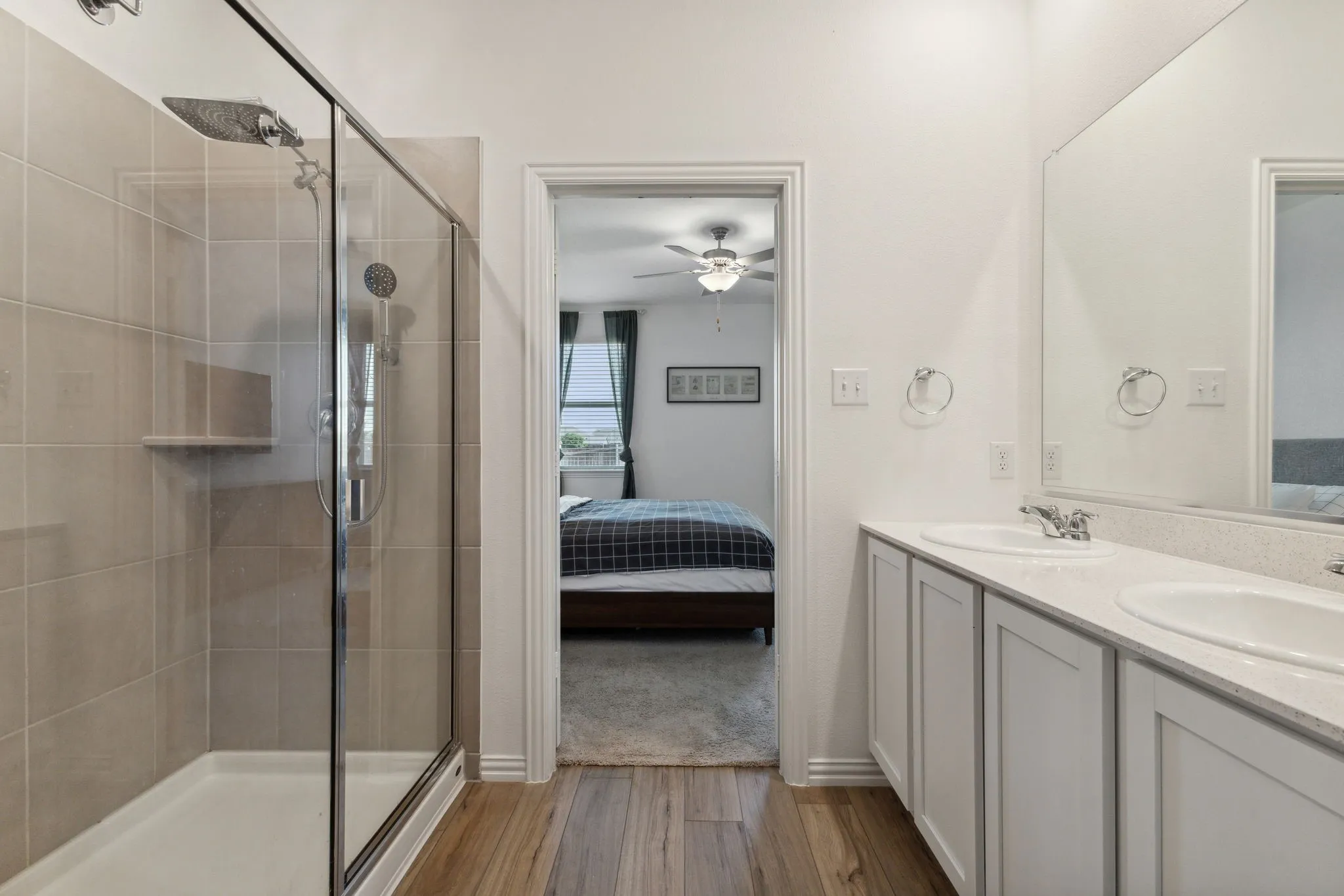 Bathroom featuring a glass-enclosed shower with tiled walls and a built-in shelf