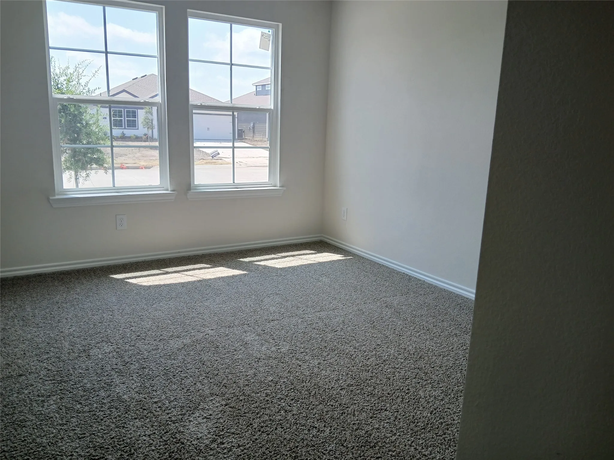 Neutral-toned wall paint and textured carpeting