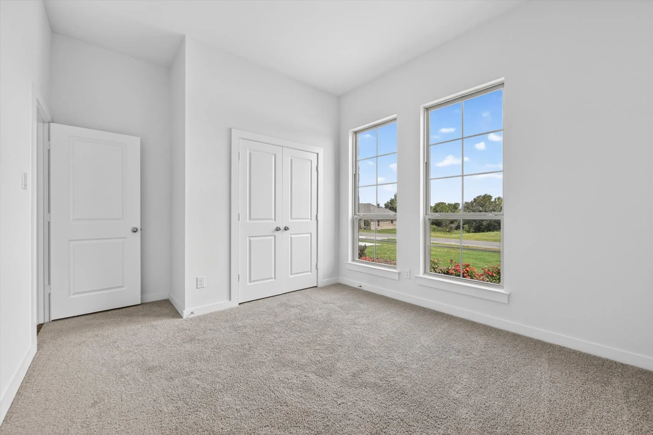 Neutral Toned Walls, Tall Ceilings, Double Closet Doors in Third Bedroom