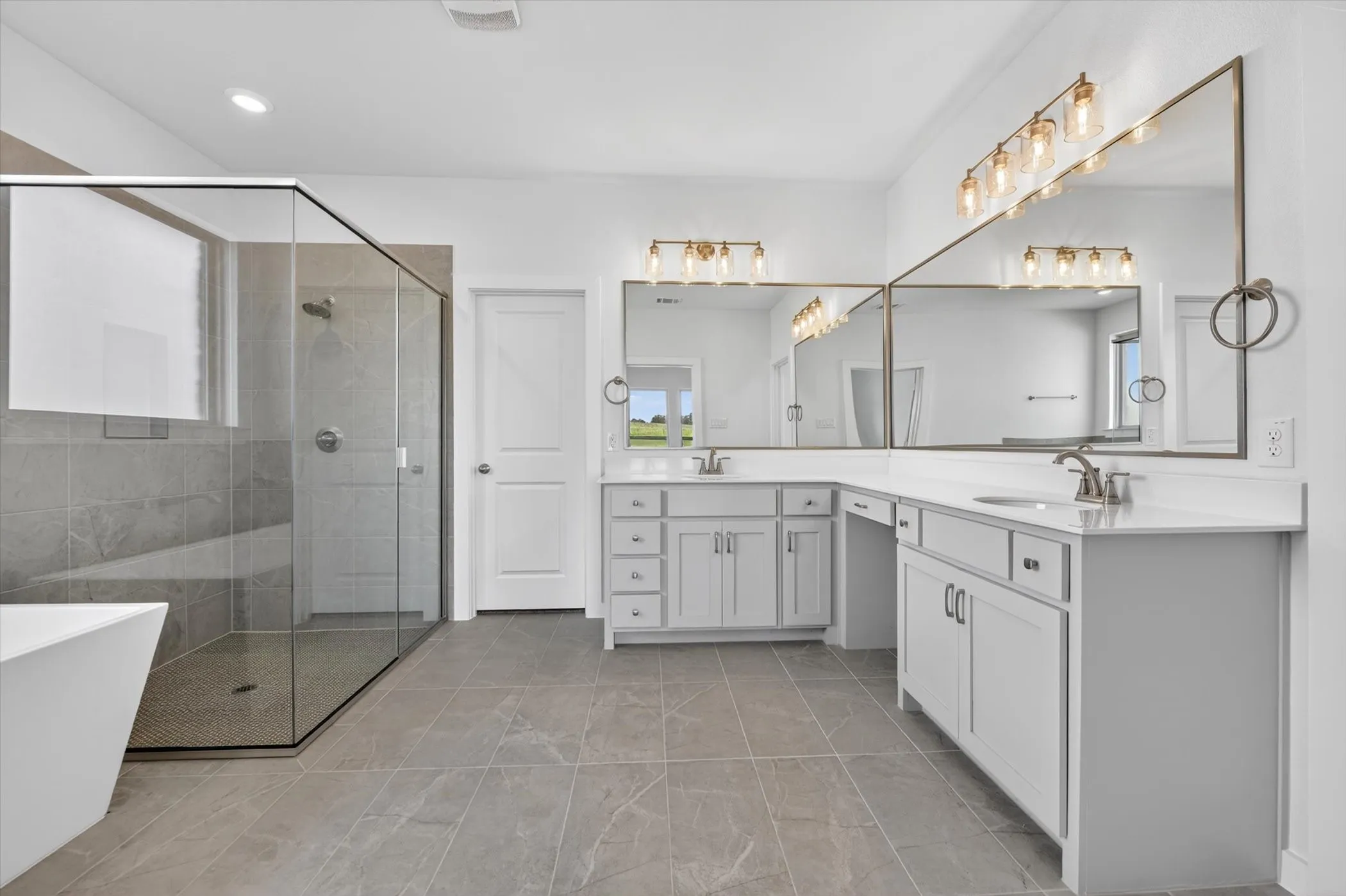 Freestanding soaking tub with wall-mounted faucet, complemented by a glass-enclosed walk-in shower featuring a built-in bench