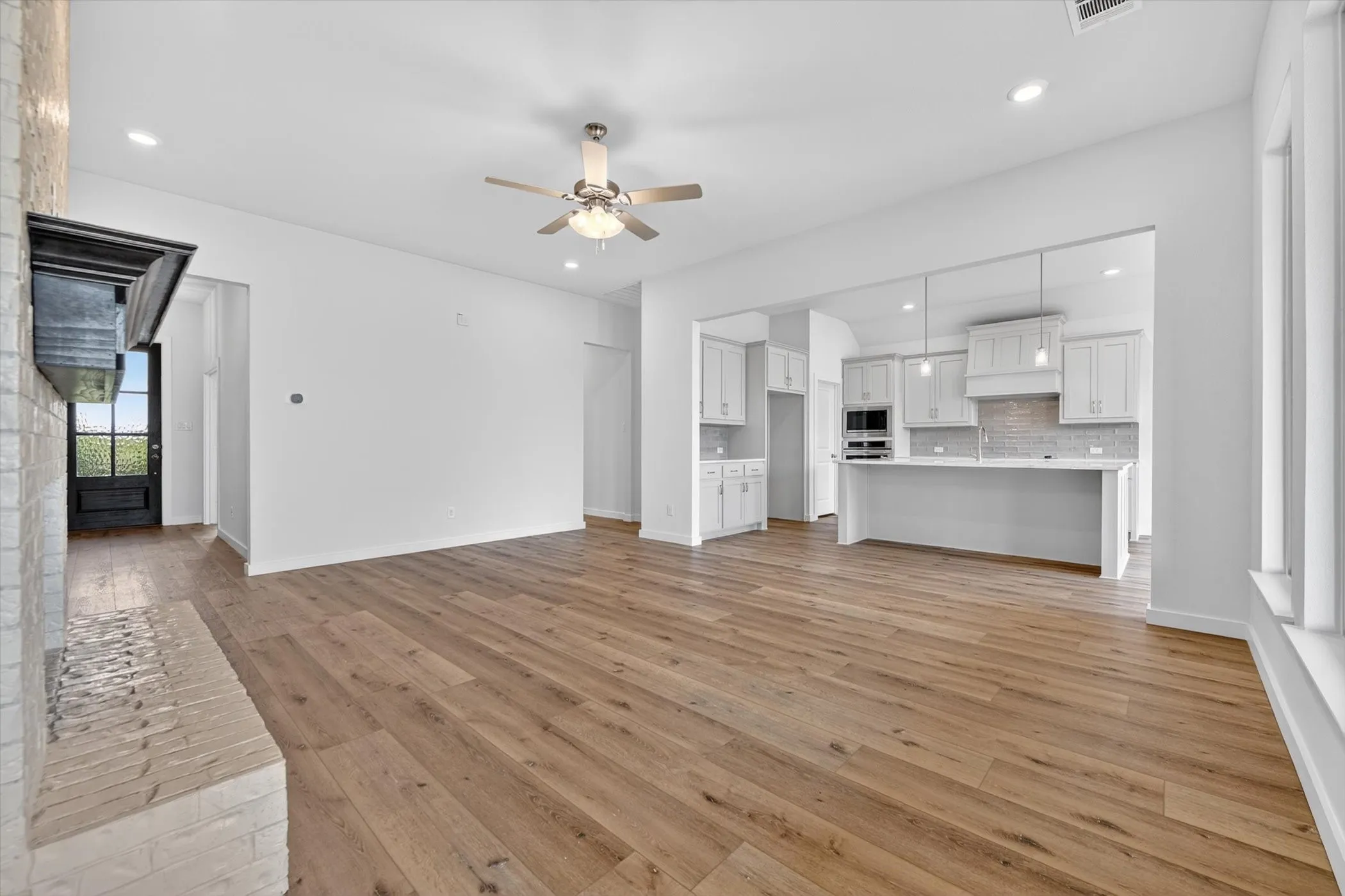 Spacious kitchen and dining area with wood-finish flooring