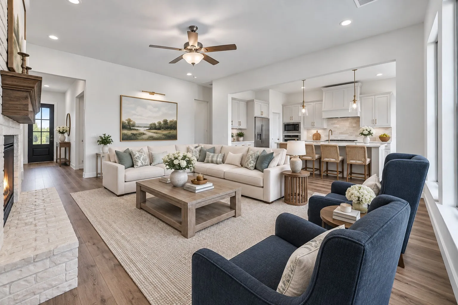 Spacious open-concept living area featuring wood-finish flooring, a white brick fireplace with a dark mantel, and recessed lighting