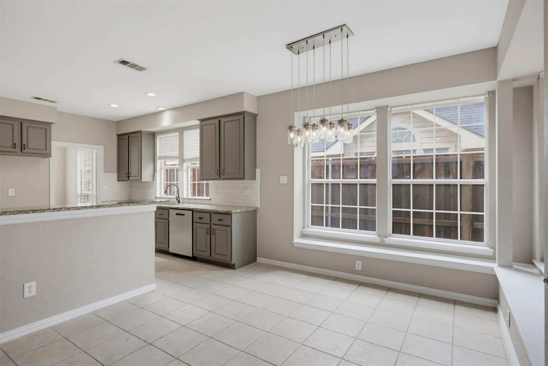Kitchen and dining area featuring ceramic tile flooring