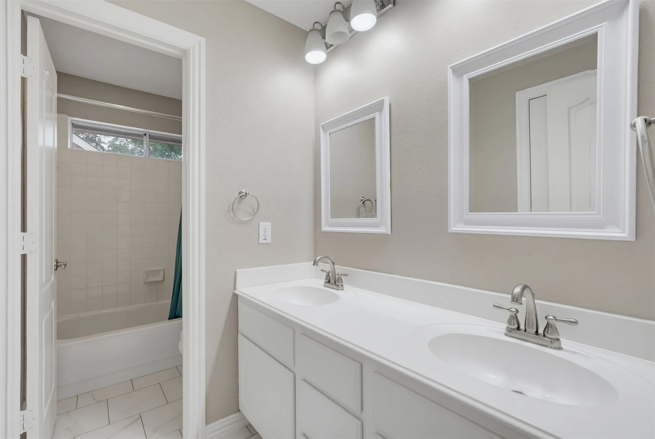 White dual vanity with integrated sinks and brushed nickel fixtures