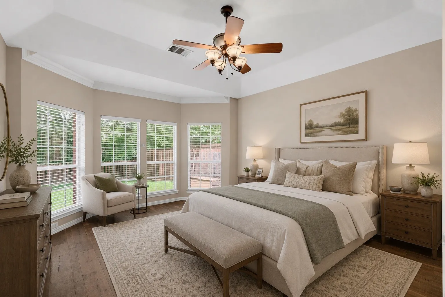 Hardwood-finish flooring complements the tray ceiling with a built-in ceiling fan