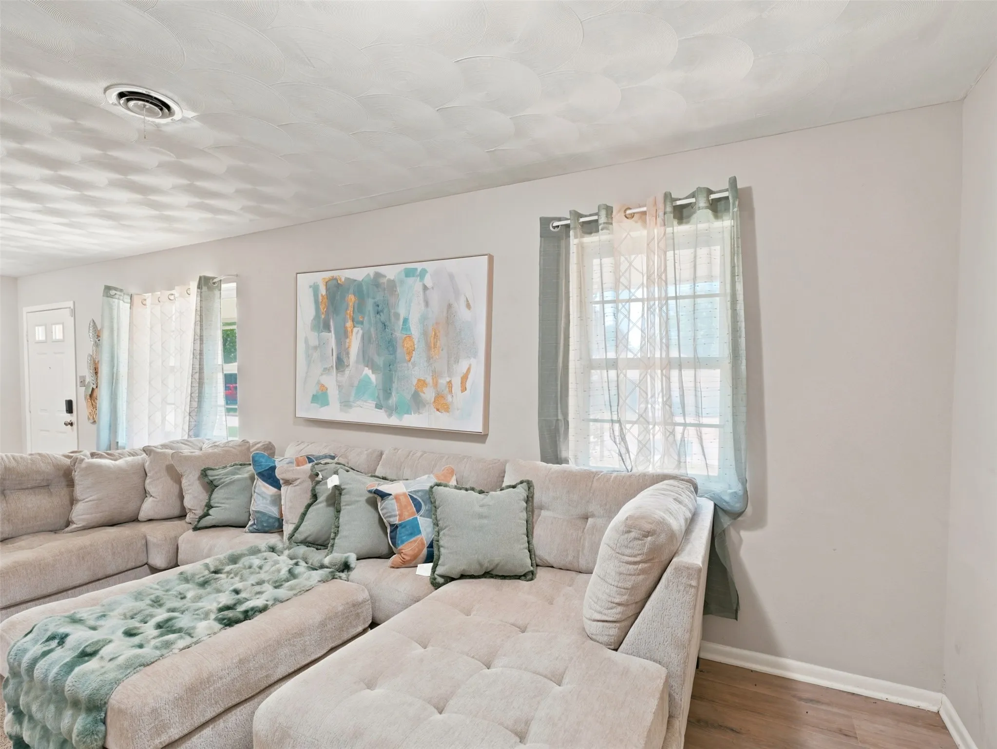Light-filled interior featuring neutral wall tones and wood-finish flooring