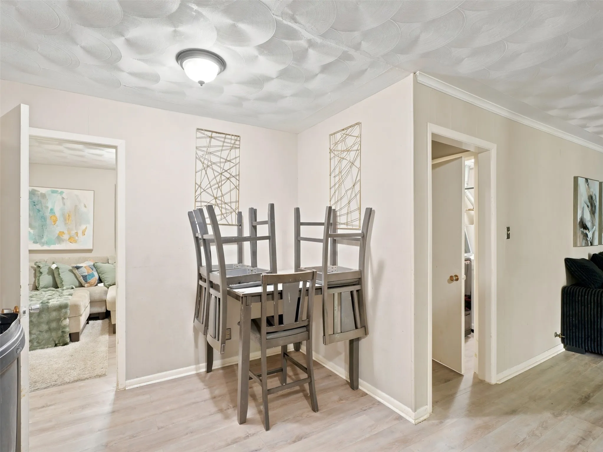 Dining area featuring wood-finish flooring and a textured ceiling
